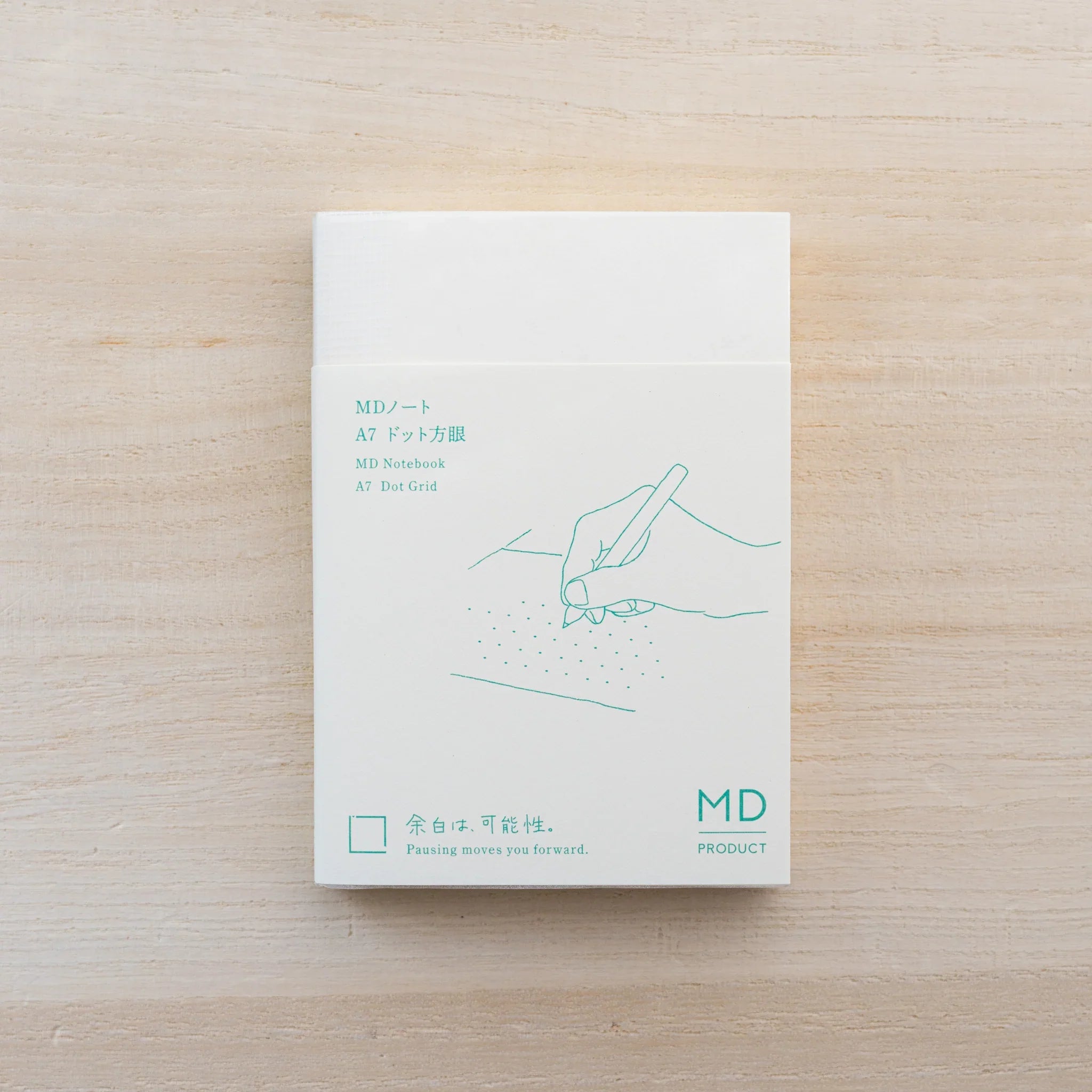 MD Notebook A7 opened flat, blank cream spread with small MD logo