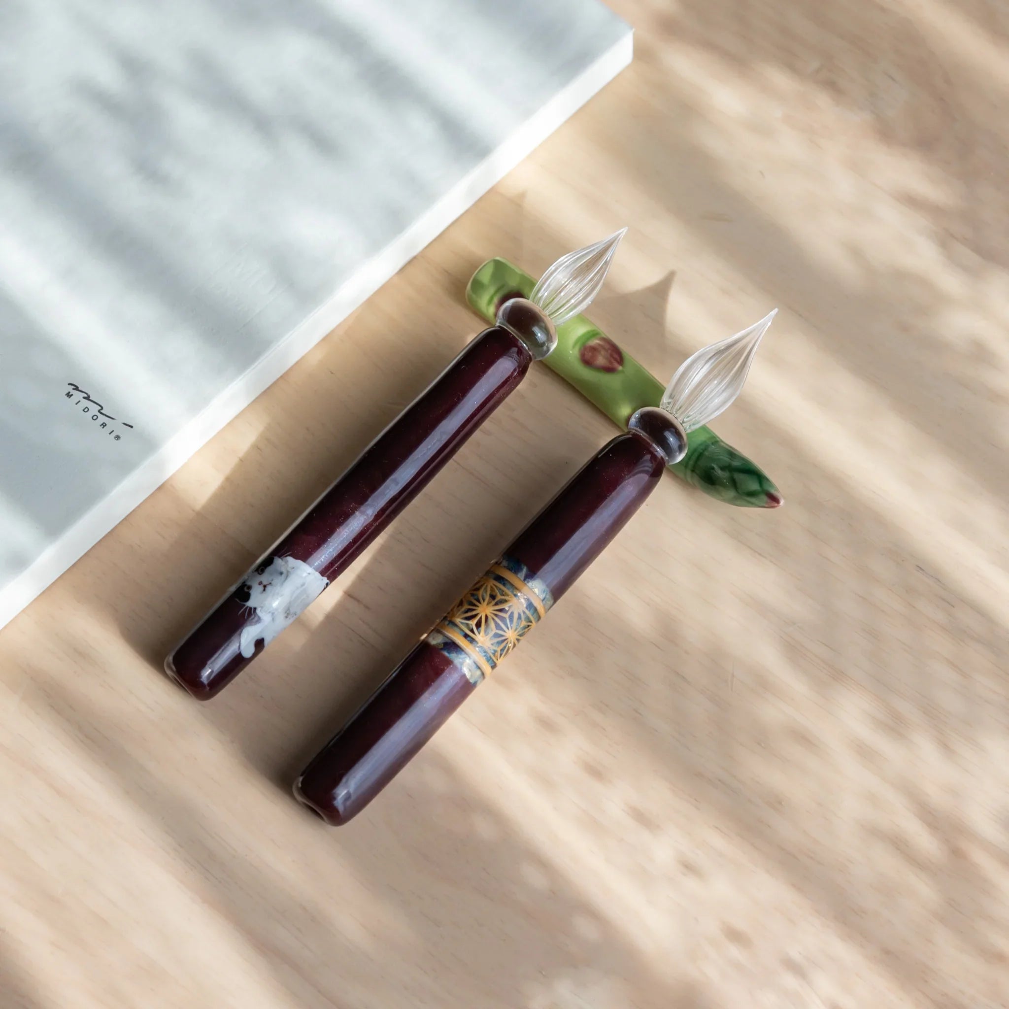 Sage green asparagus ceramic handcrafted pen rest with tightly bundled spears throughout detailed form close shot