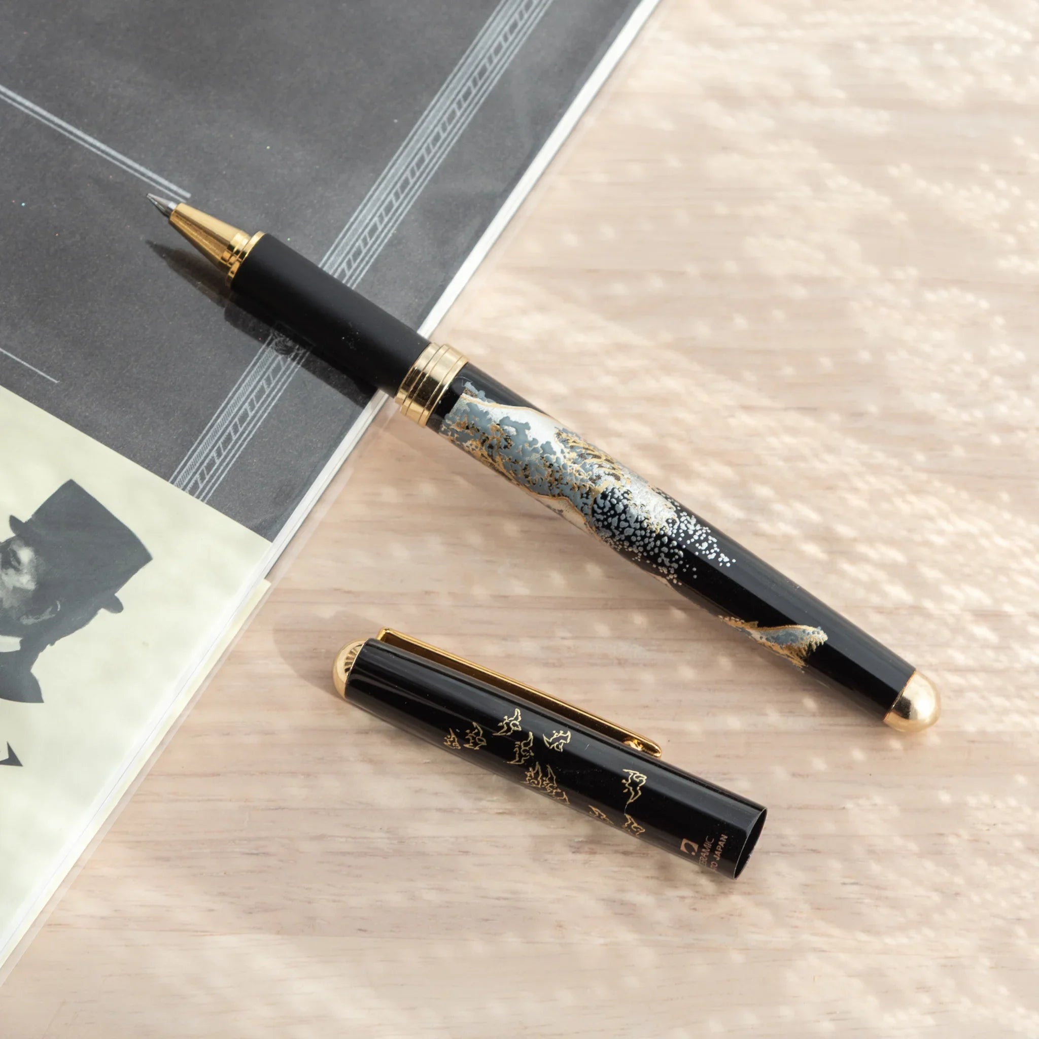 Maeju Yamanaka ballpoint pen body with Great Wave silkscreen and gold tip, cap with gold Japanese characters on wood