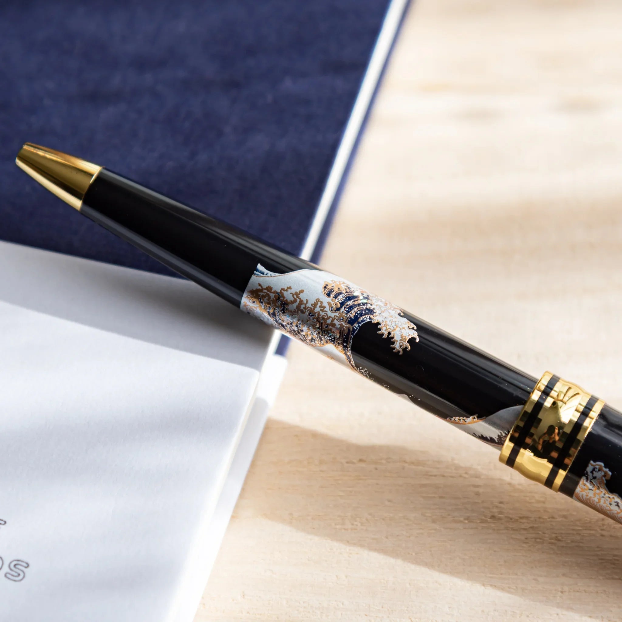 Great Wave ballpoint with extended writing point tip ready for use shown in composition composition shown