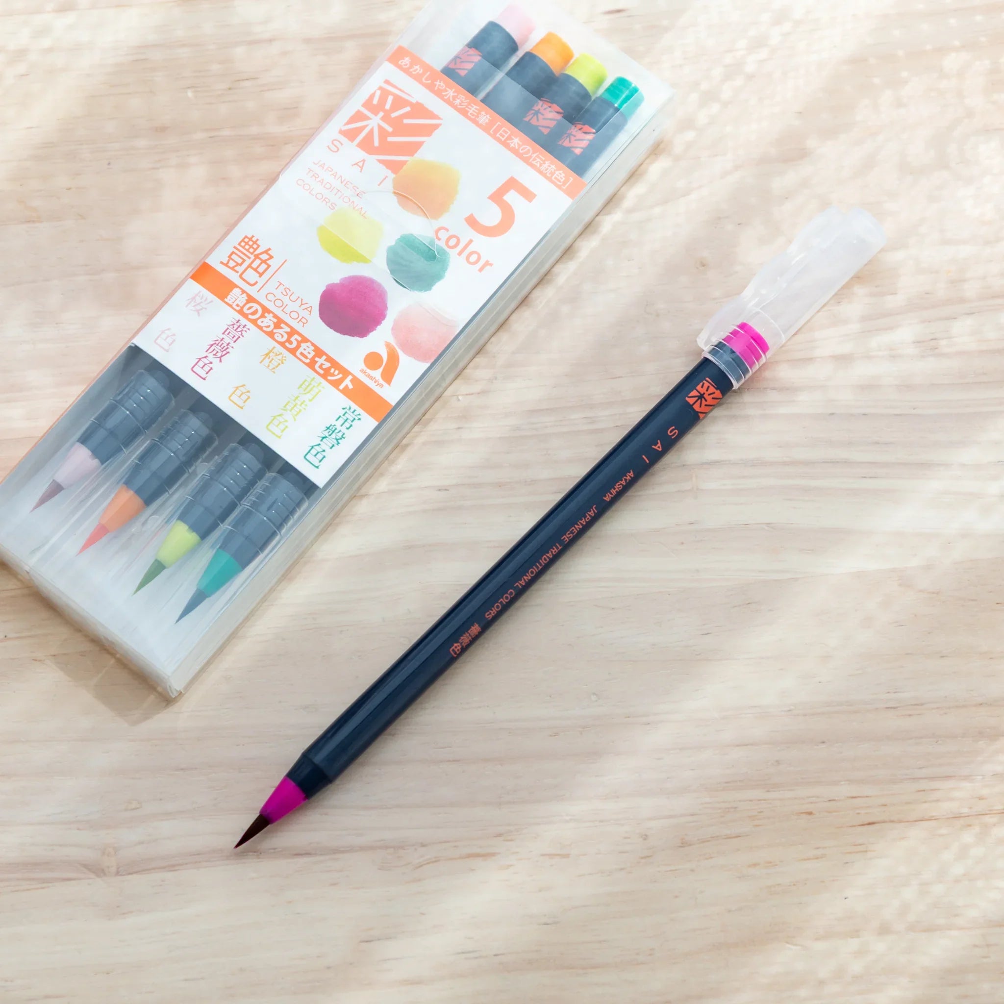 Packaging for Akashiya Sai luminous color brush pen set featuring bright glowing color swatch palette