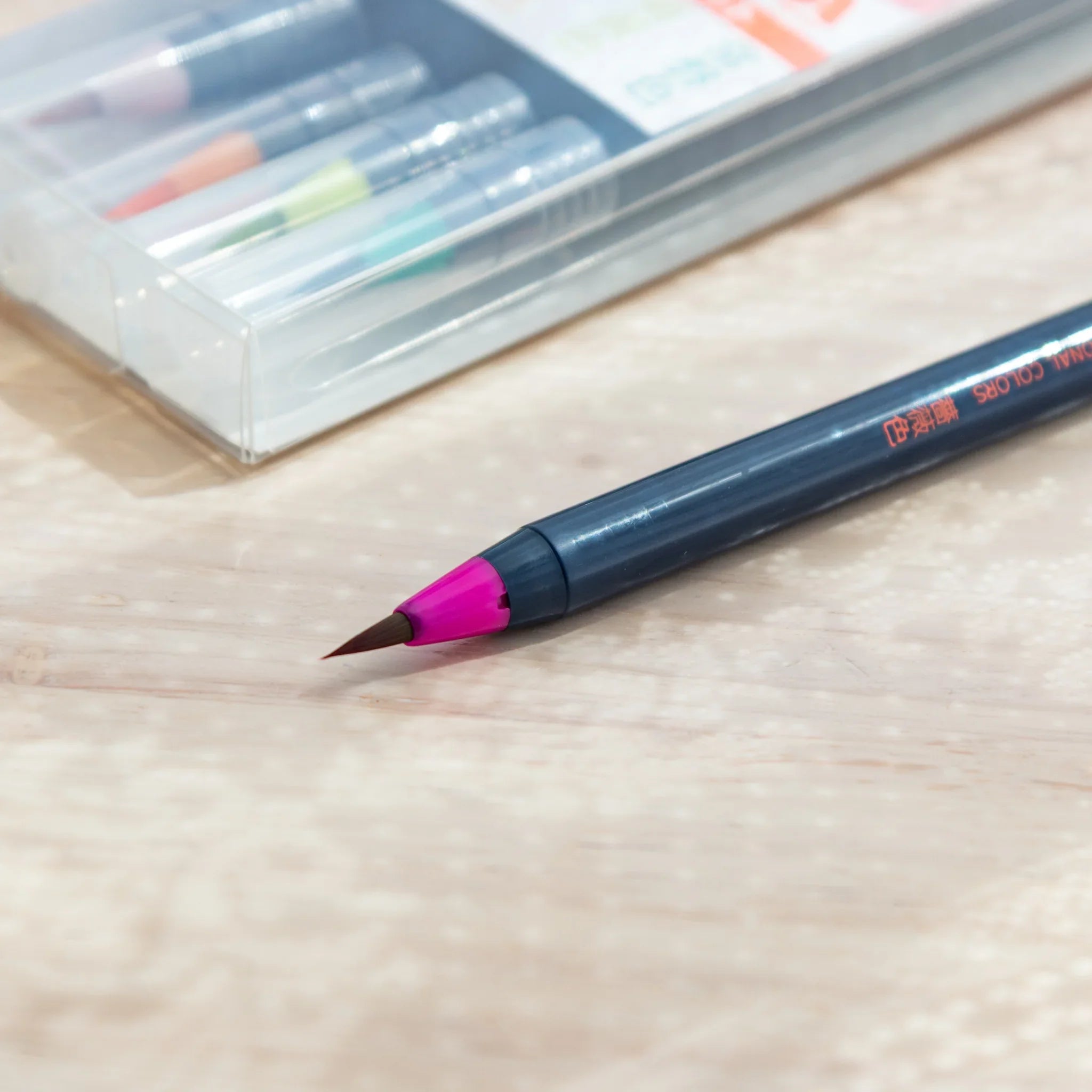 Five luminous colored brush pens showing vibrant glowing pigments ideal for striking illustration art