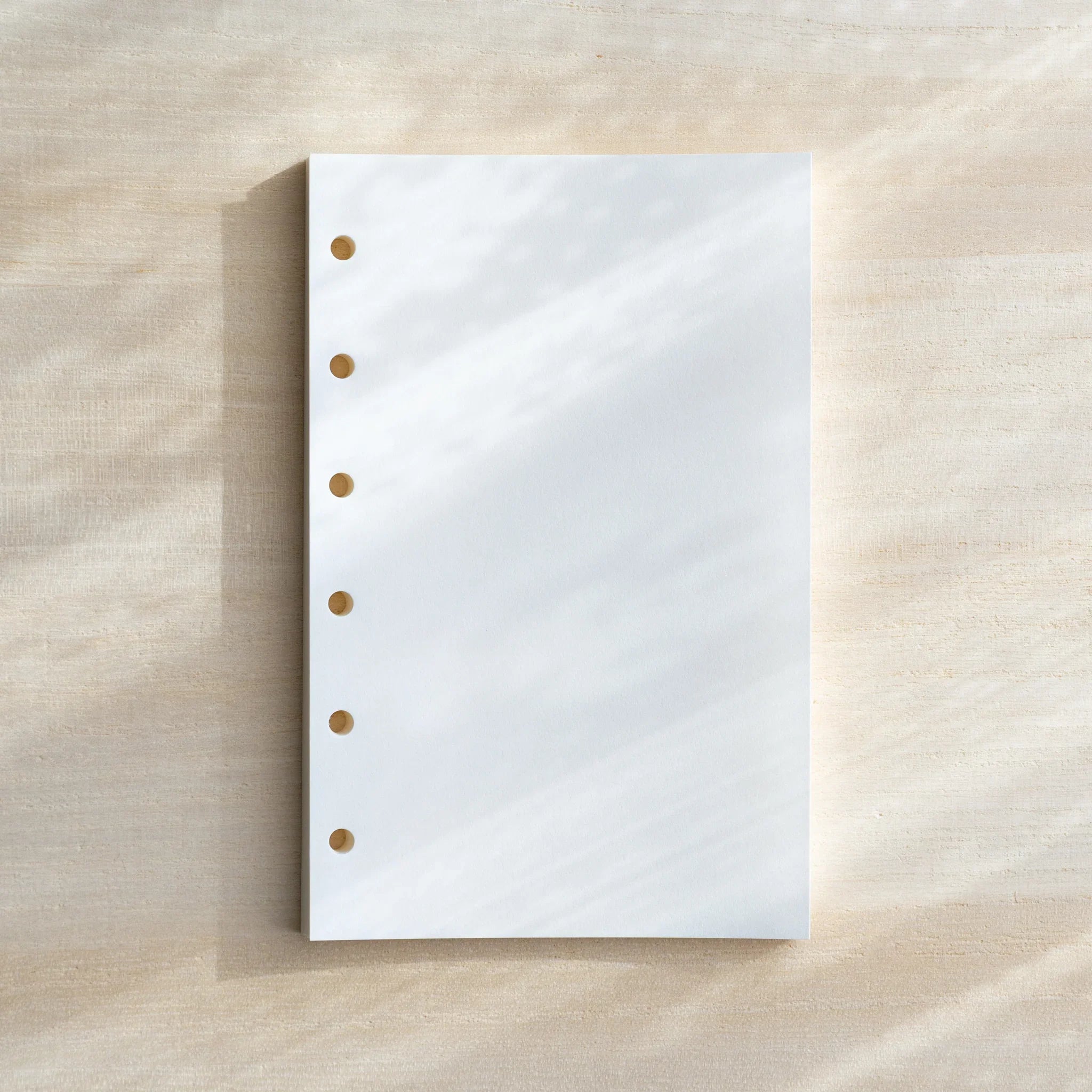 Bank Paper Mini 6 planner refill showing stack of cream colored paper sheets with printed text lines