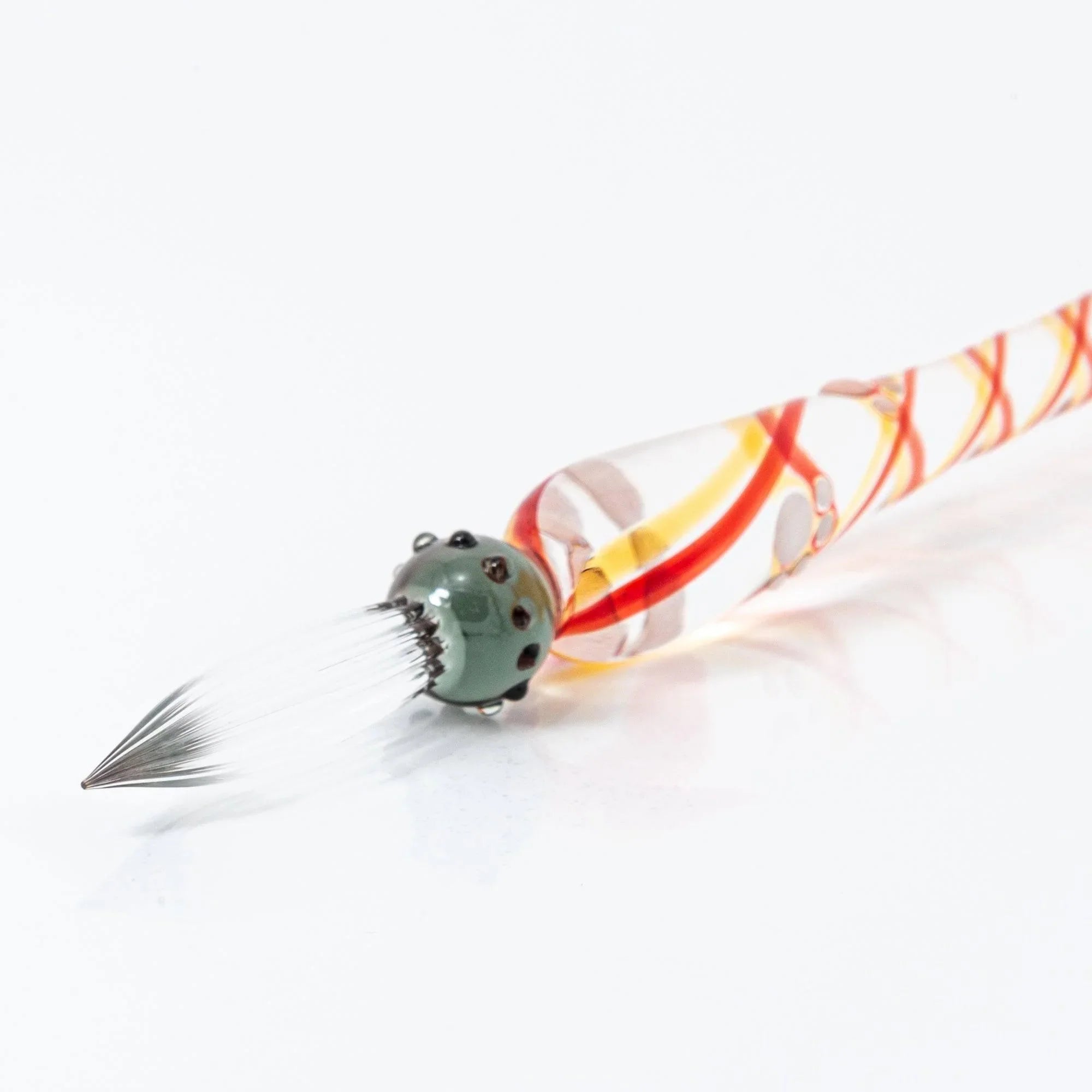 Black Nyanko cat glass dip pen angled view showing dark green cat figure and amber-toned translucent section