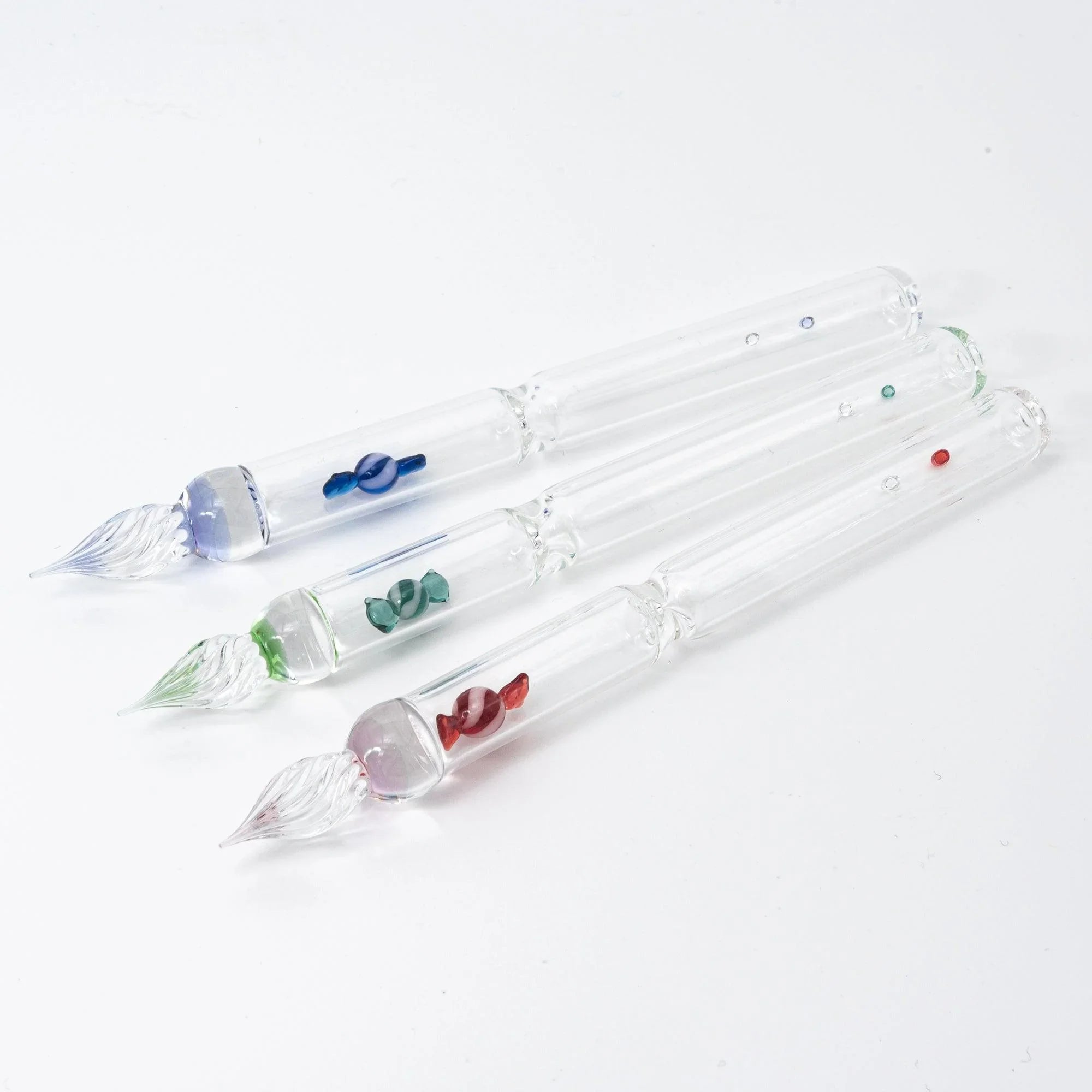 Blue candy glass dip pen being used for calligraphy writing demonstrating ink flow and fine line writing capabilities