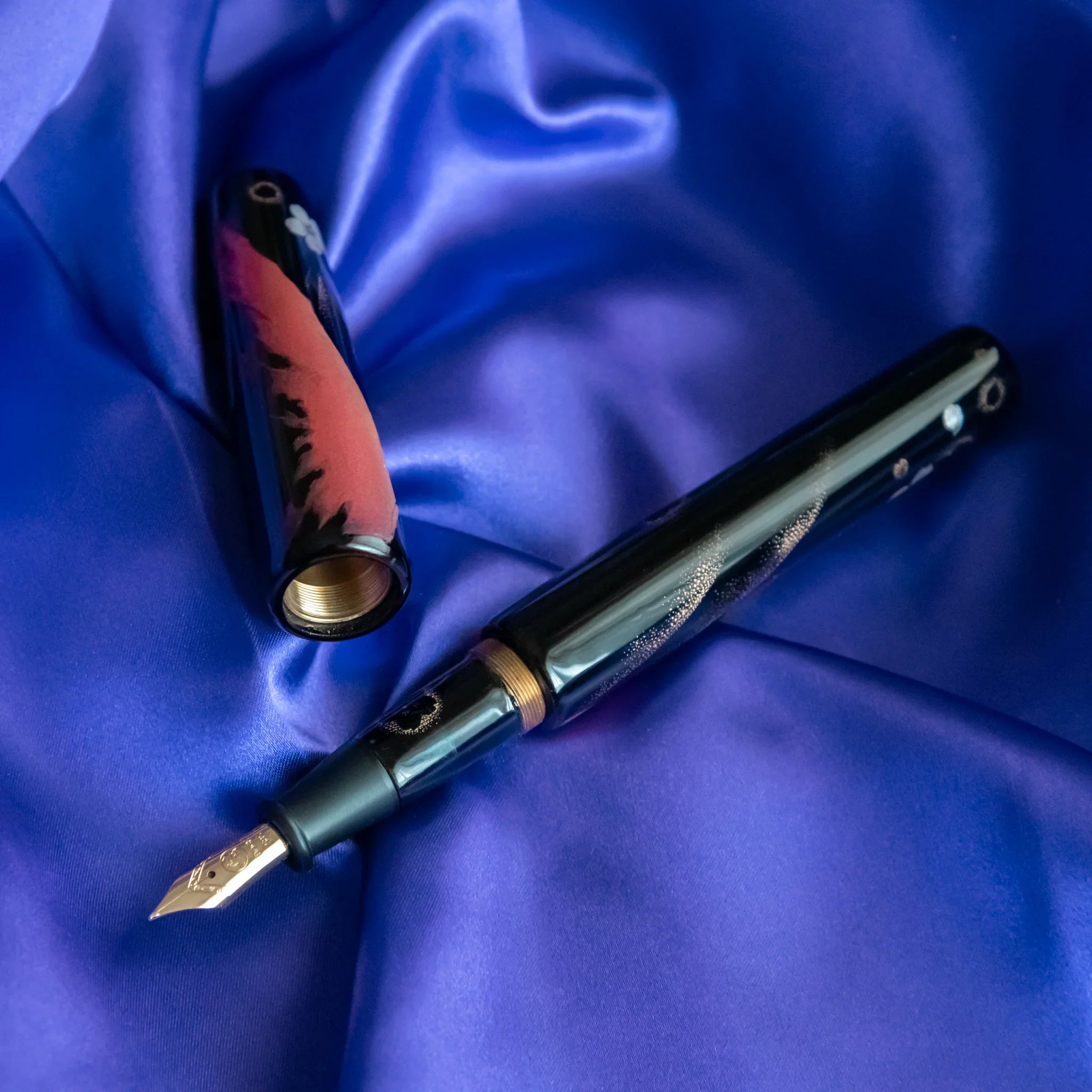 Open gift box revealing Chinkin Sakura and Fuji pen with blue silk and accessories showing product quality and design details