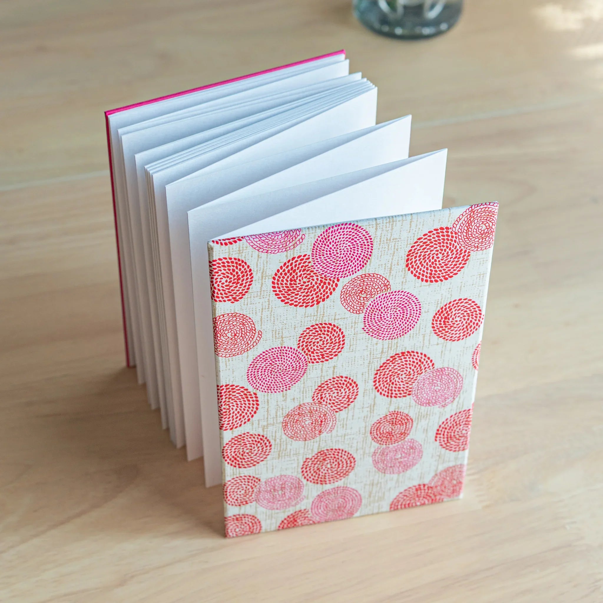 Open Circle of Blossoms goshuincho showing white interior pages and decorative circular floral cover