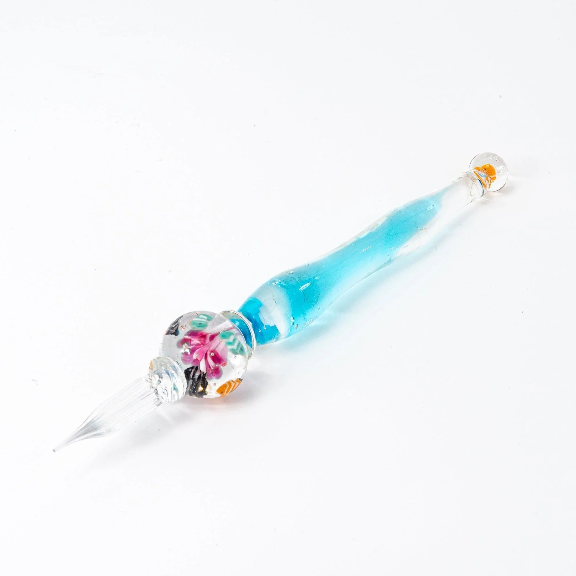 Japanese glass dip pen side view with gray-tinted aquarium barrel containing orange-white striped clownfish detail