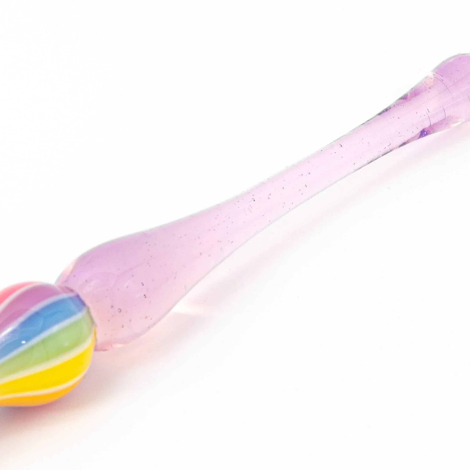 Lifestyle shot of Rose variant glass dip pen being used for artistic writing or illustration showing product quality and d