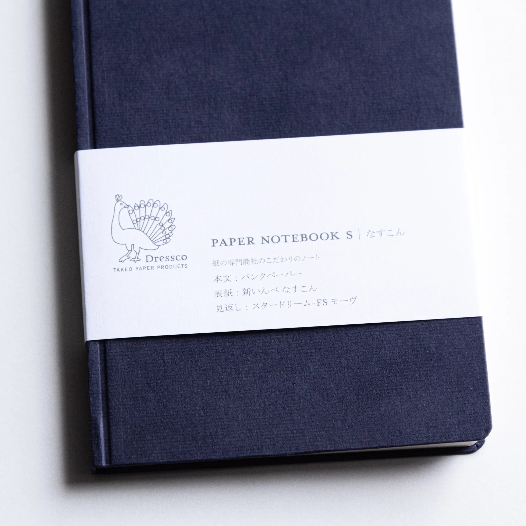 Flat lay of Dressco Bank Ledger Paper A6 notebook showing the full cover from above in a clean overhead shot