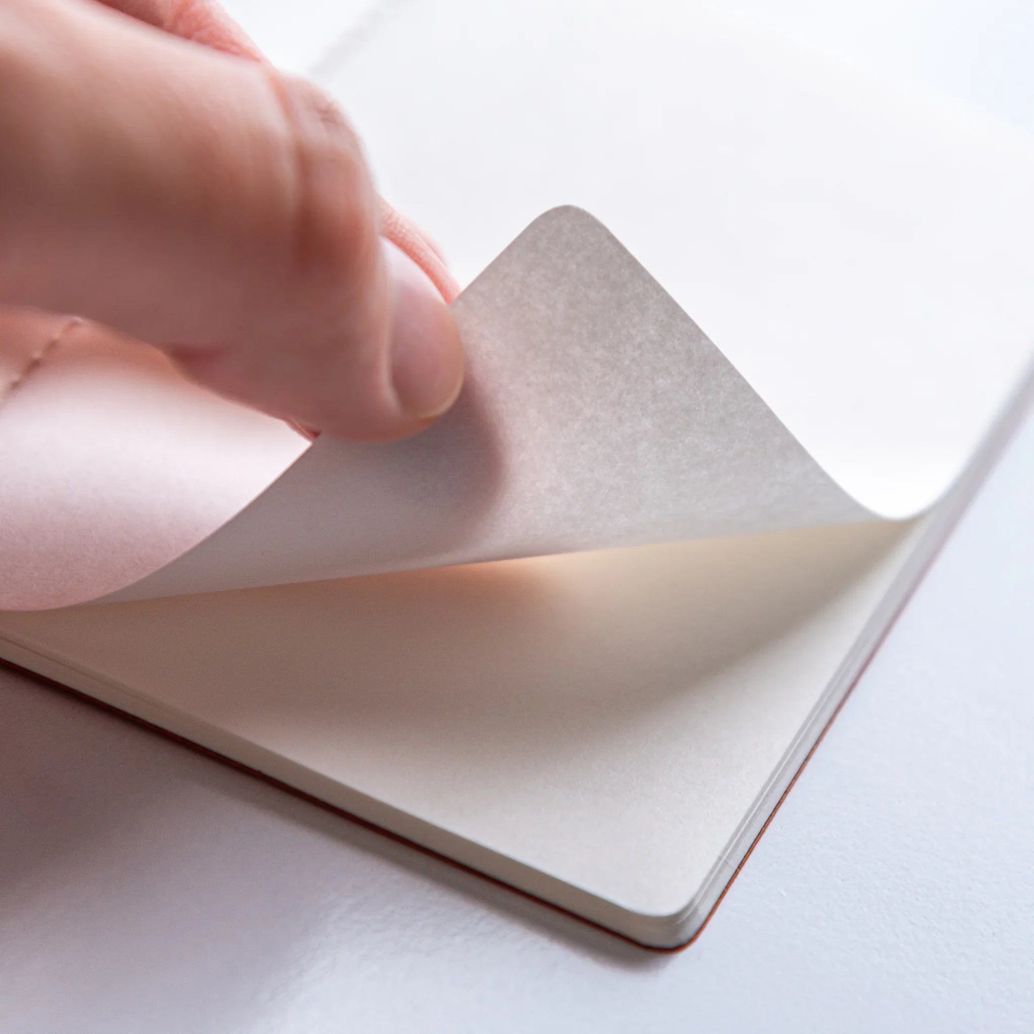 Charcoal Dressco A6 notebook with white product wrapper displaying Dressco bird logo and branding clearly visible