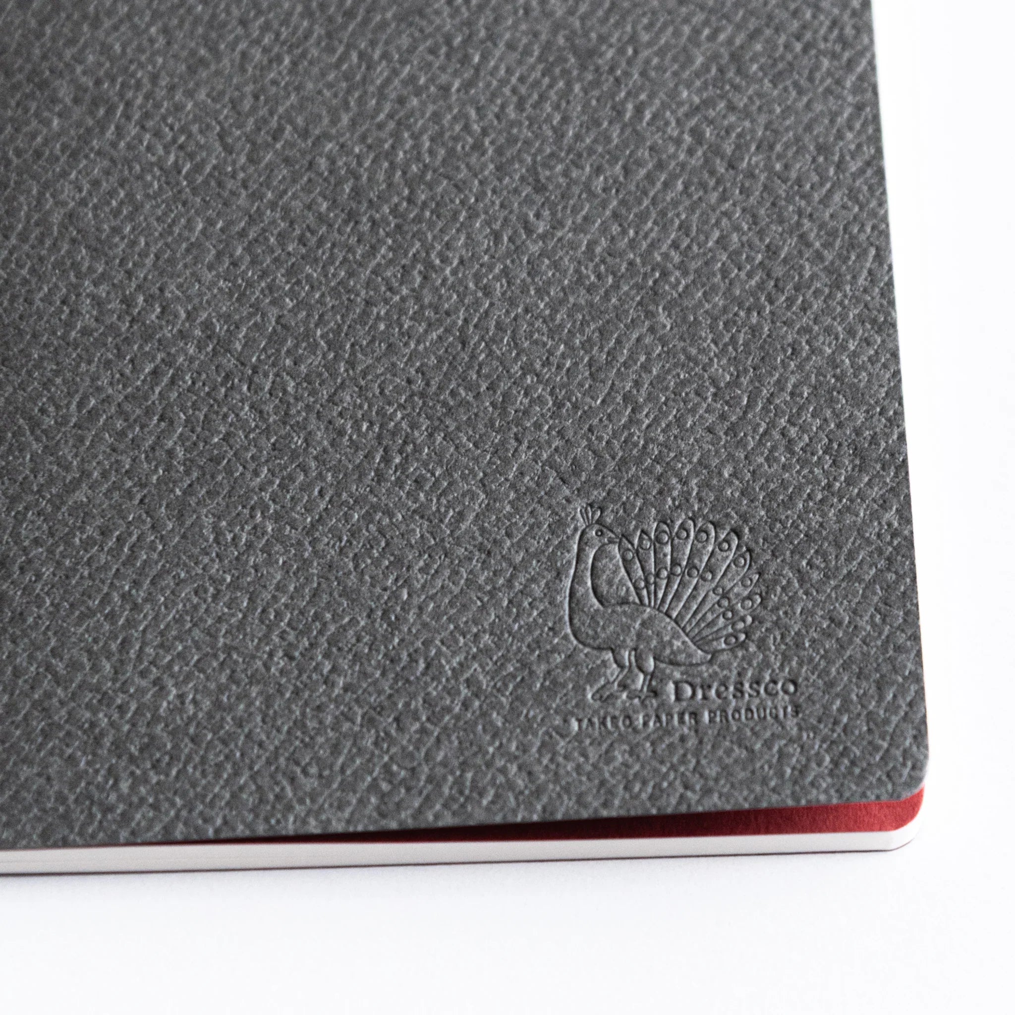 Interior page detail of Dressco A6 notebook showing ruled lines pattern and natural cream color paper texture quality