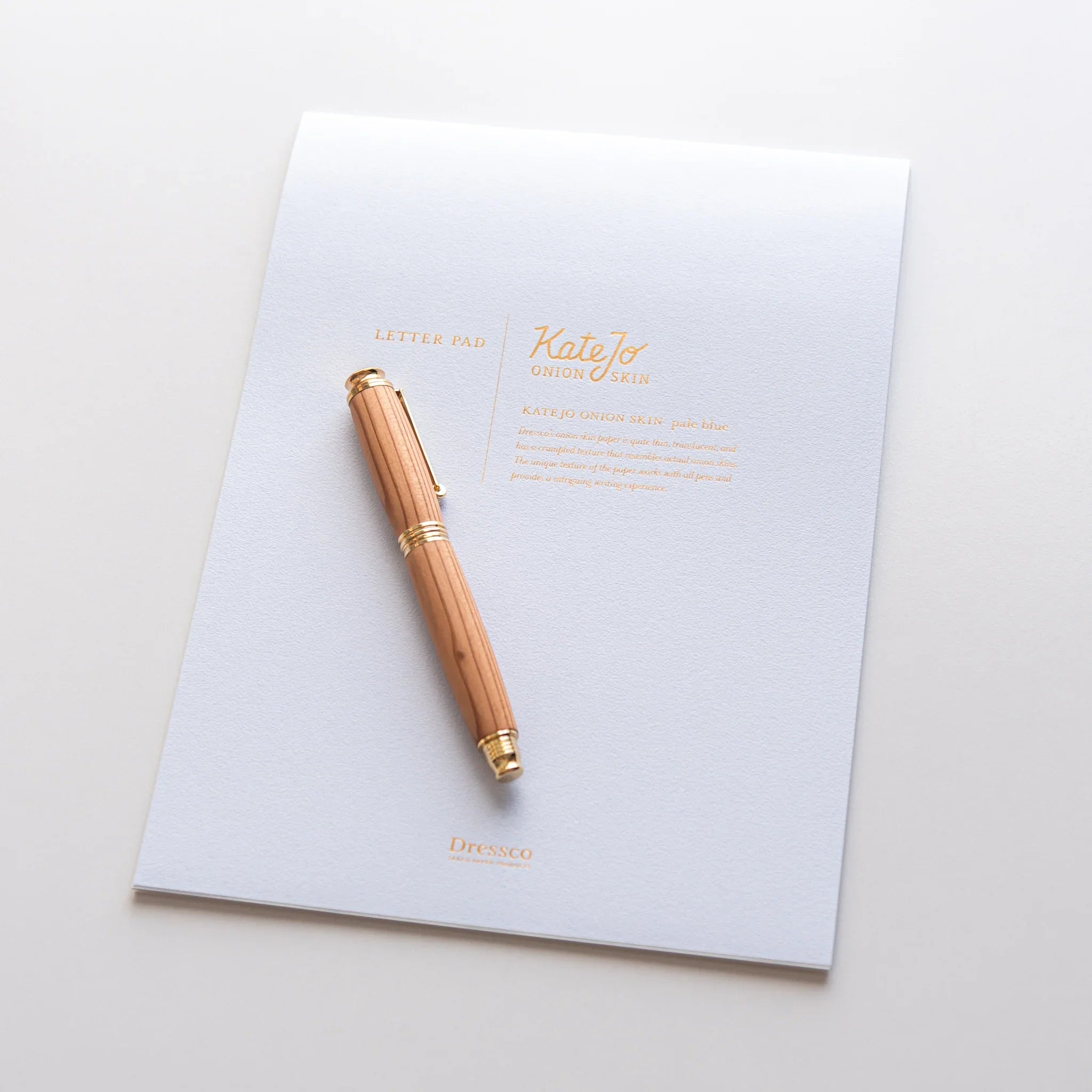 Flat lay of Dressco writing pad with envelope and coordinating stationery items for writing and personal correspondence use
