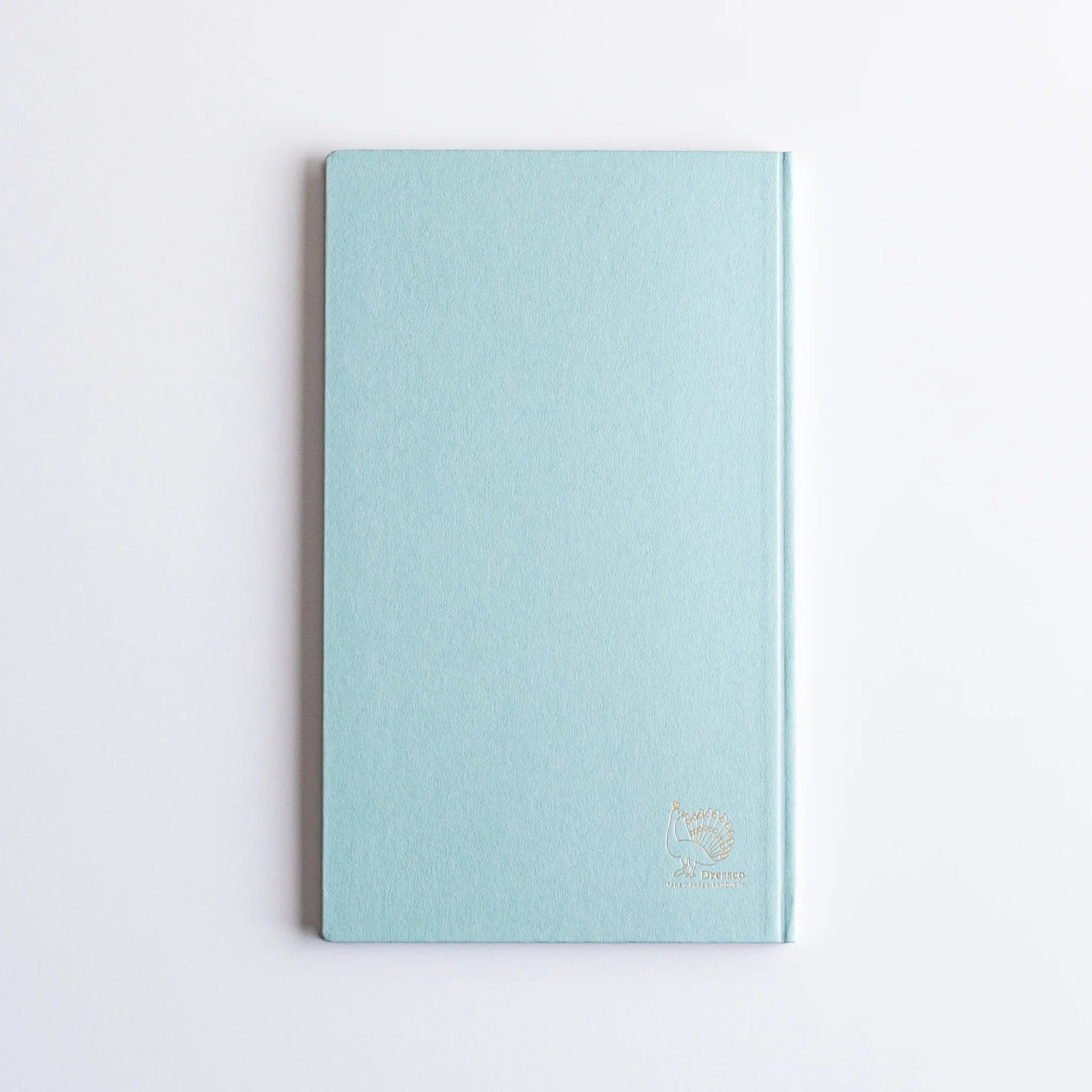 Back cover view of Dressco Spica Laid Bond Paper B6 notebook showing paper surface quality and notebook construction