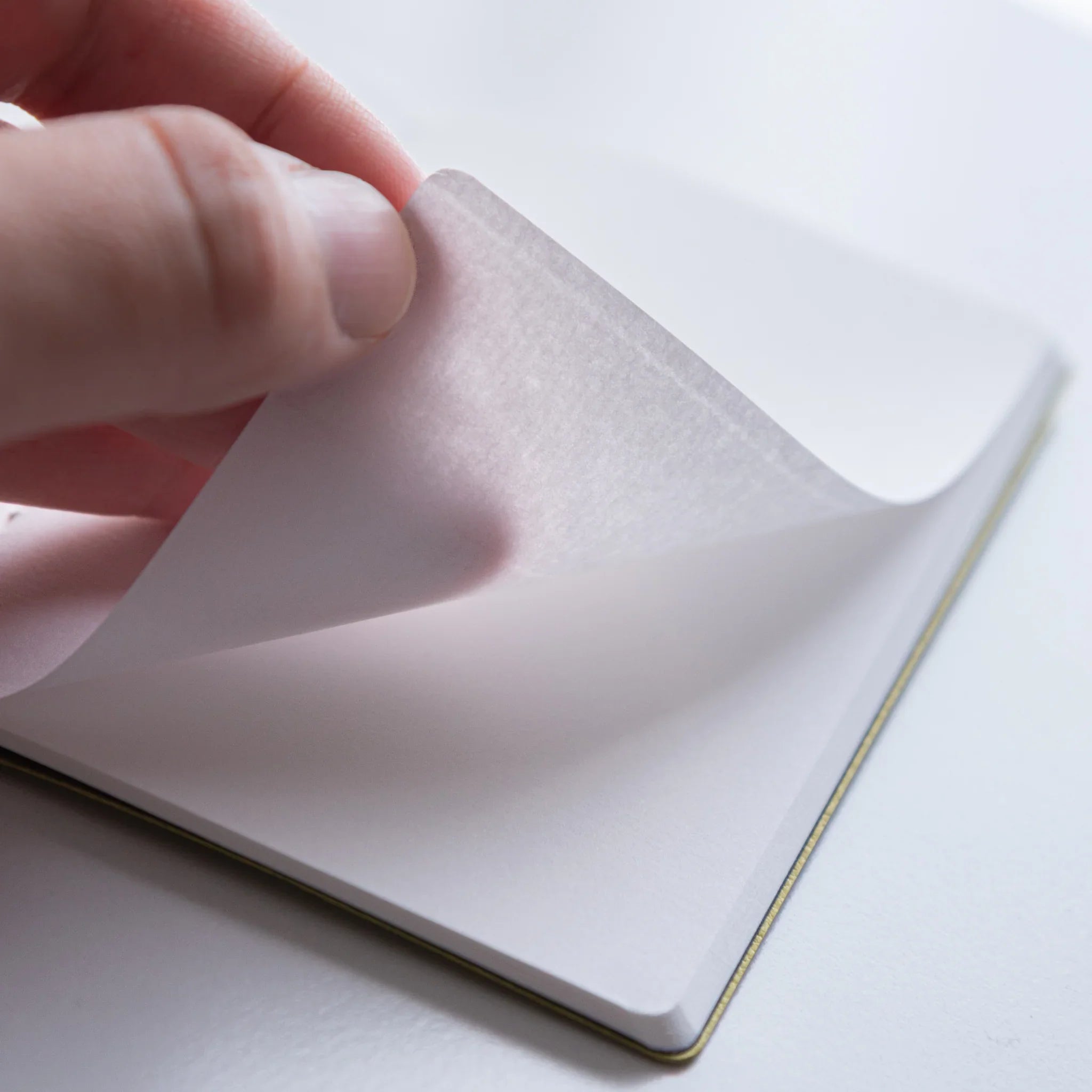 Open spread of Dressco Spica Laid Bond Stitched A6 notebook showing the interior pages and laid bond paper ruling