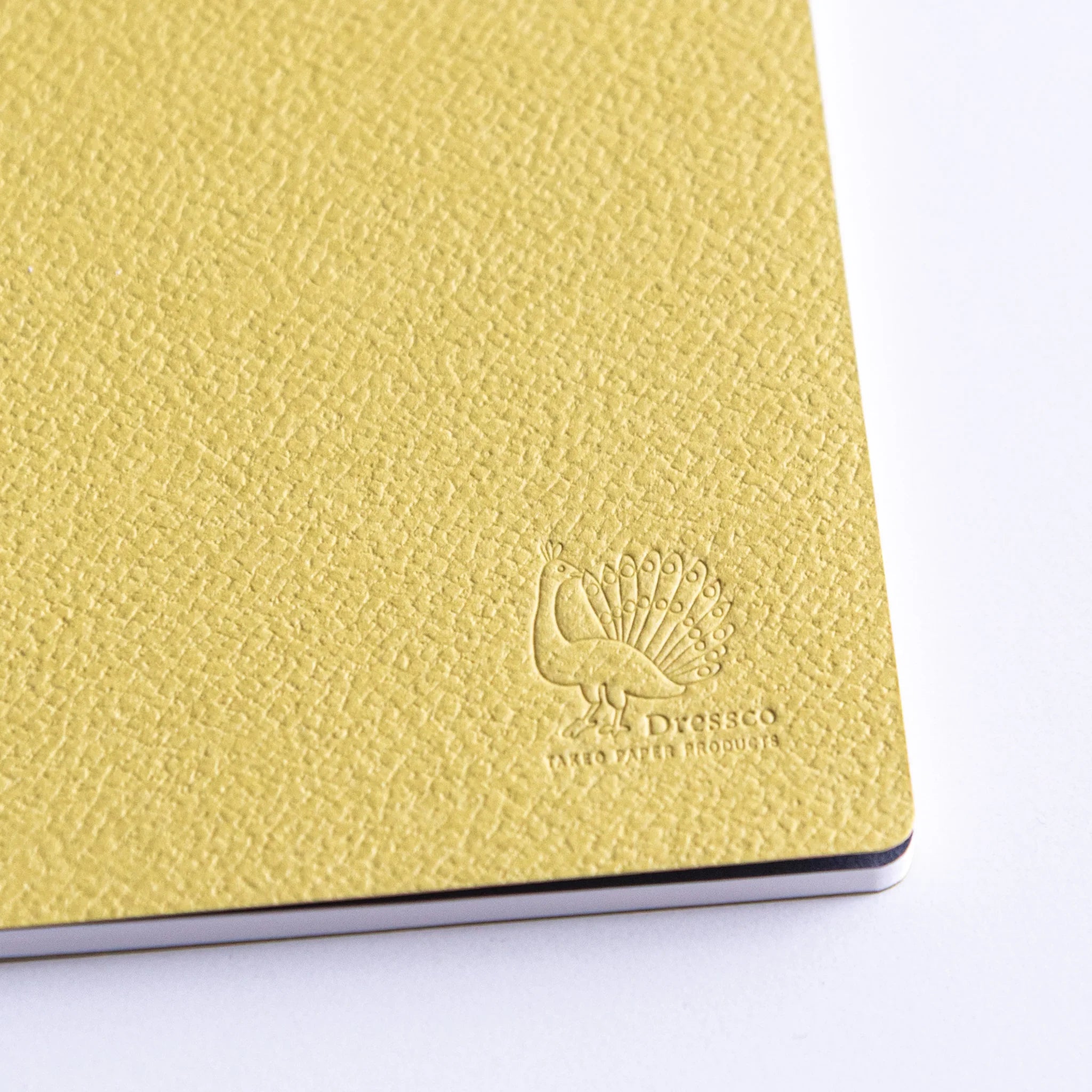 Dressco Spica Laid Bond Stitched A6 notebook placed flat showing cover and stitched spine from a top-facing angle