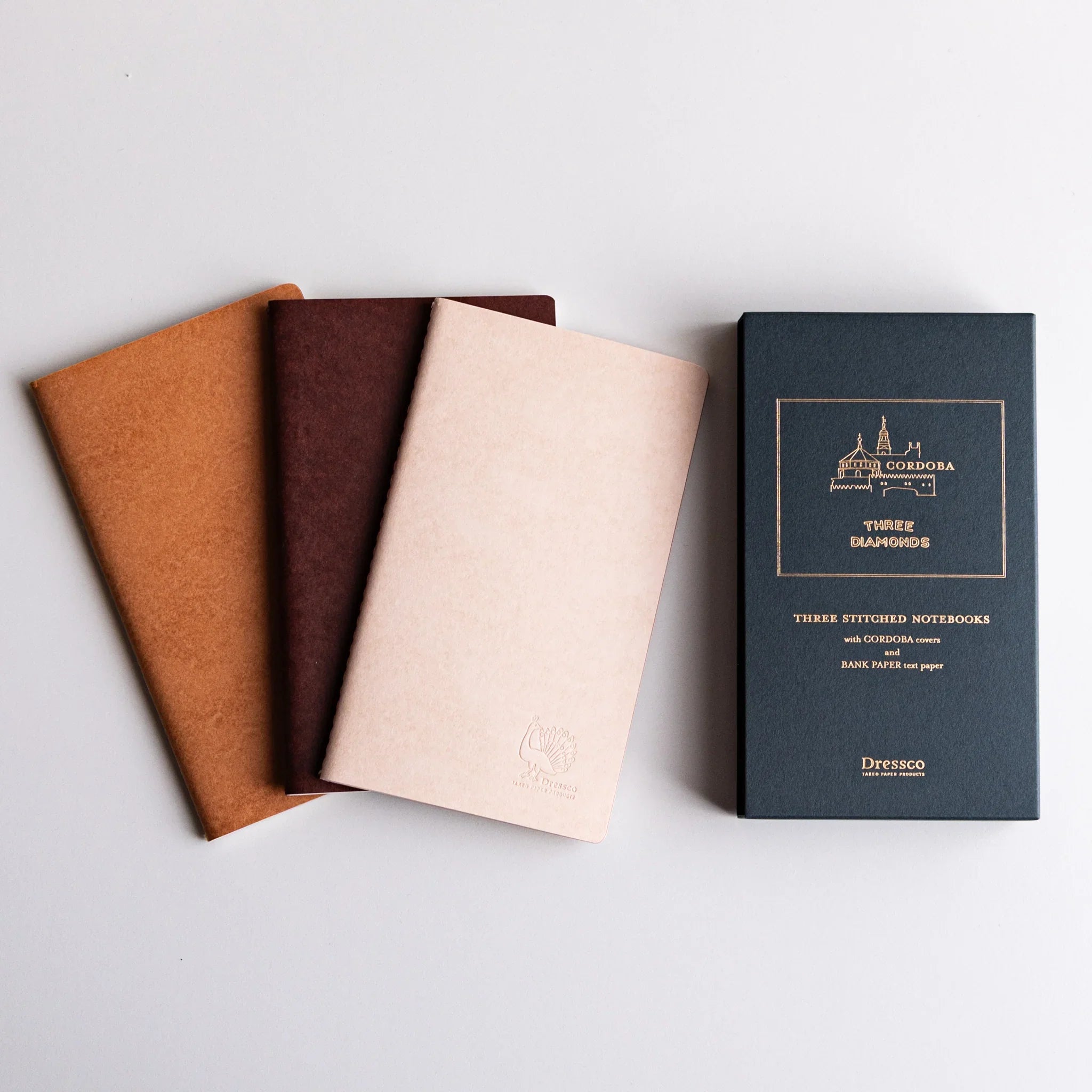 Three Dressco Bank Ledger notebooks stacked showing coordinated design and variations for accounting or journal record kee