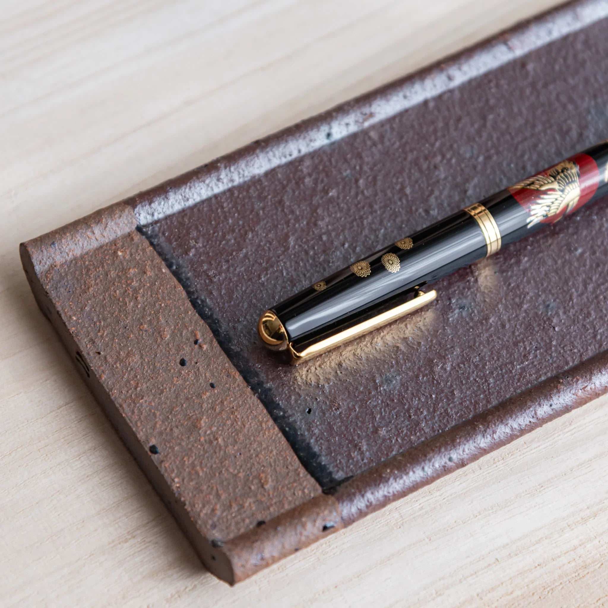 Echizen Kawara red tile ceramic pen tray with four slots shown in composition detail in detailed composition