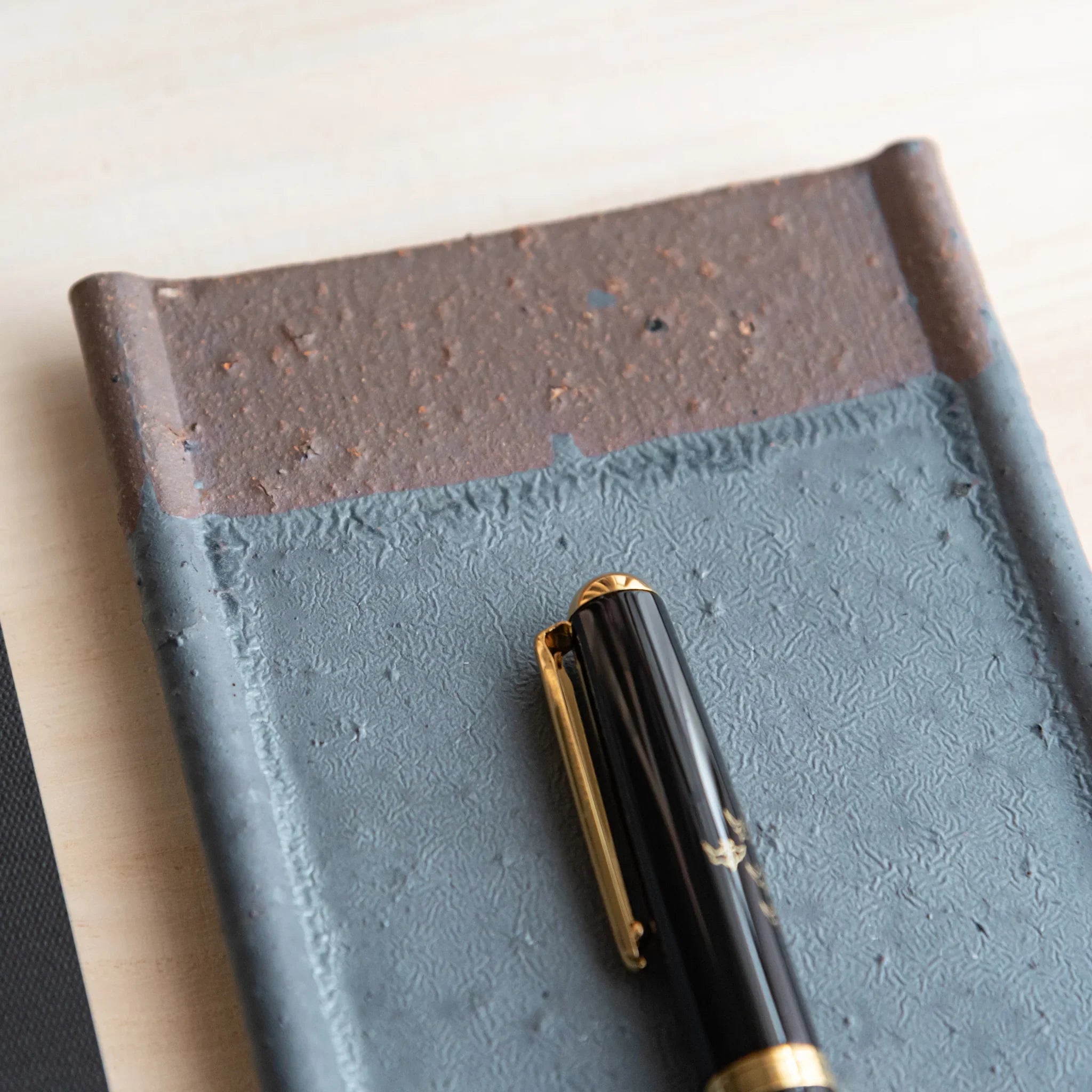 Echizen Kawara silver gray ceramic pen tray with four slots shown in composition in detailed composition