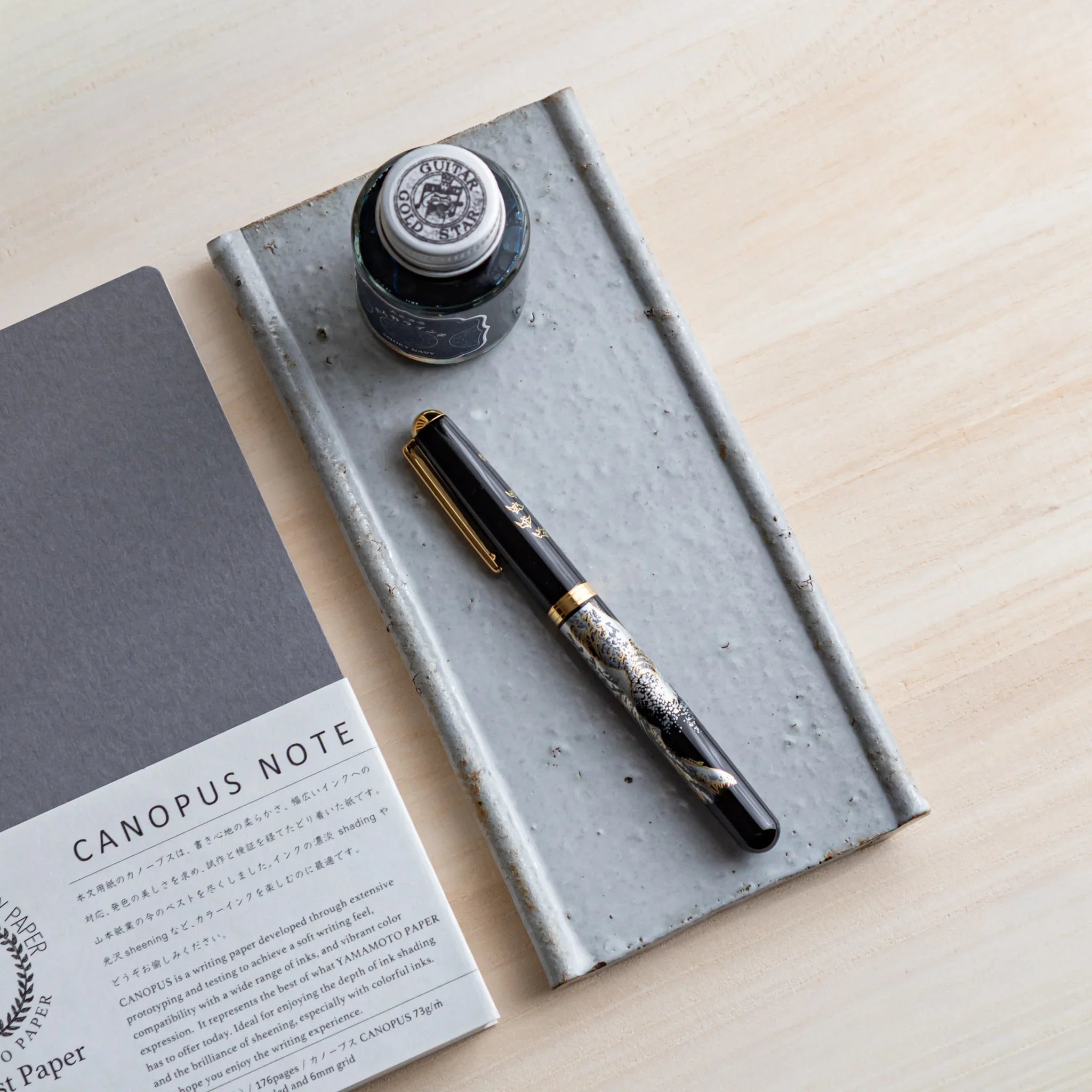 White glazed Echizen Kawara ceramic pen tray with Japanese ink bottle and fountain pen displayed displayed clearly