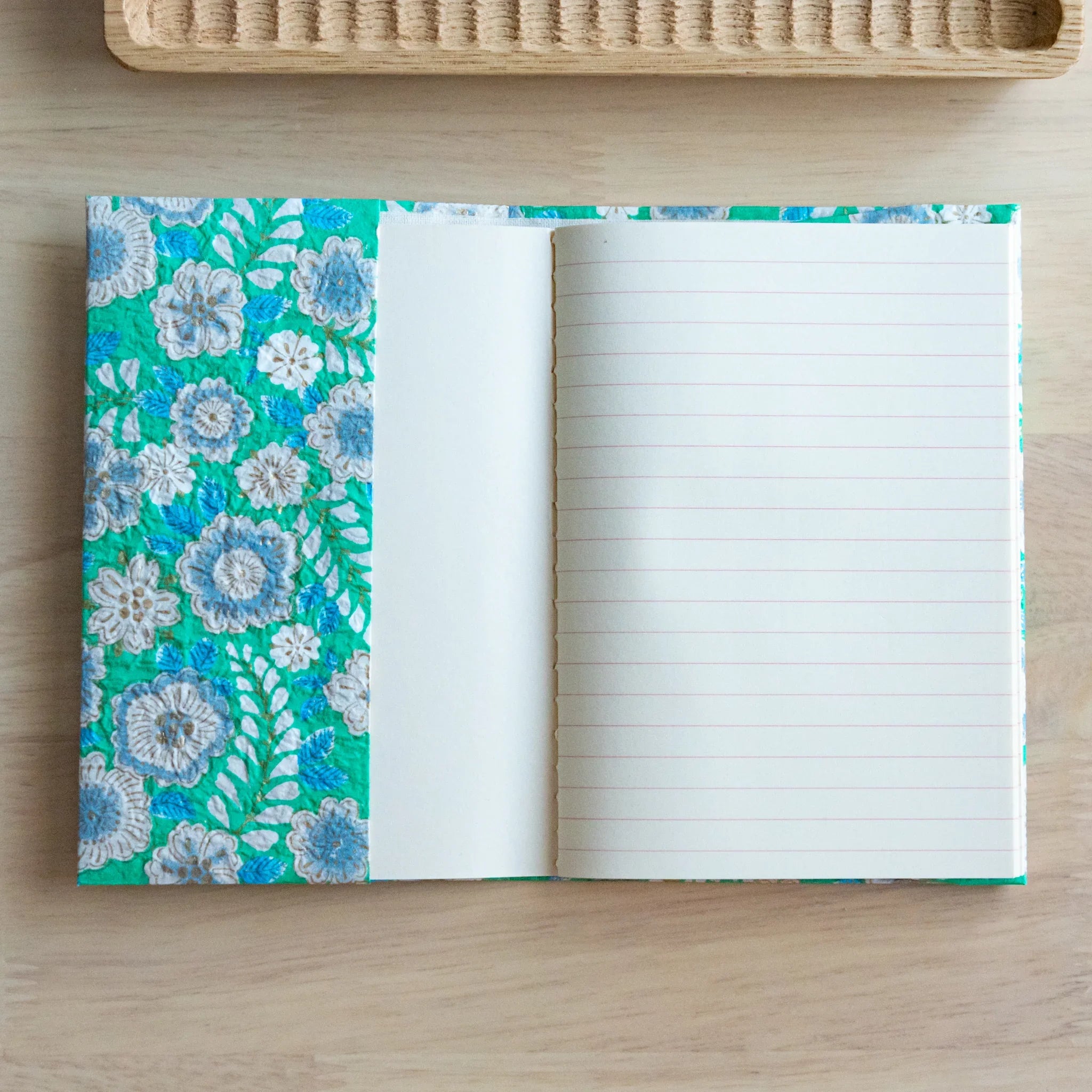 Emerald green hand-dyed yuzen washi book cover A6, detailed view of white embroidered blossoms on green surface
