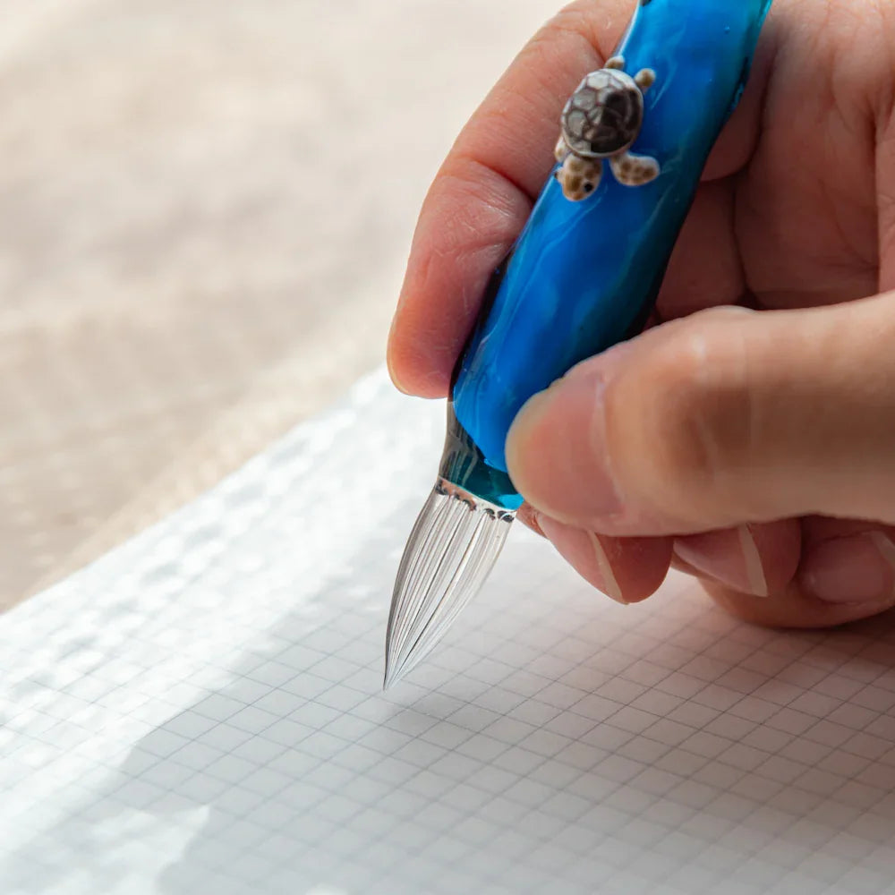 Glass dip pen with sea turtle floating decorative figure inside transparent barrel, enclosed detail hand-blown glass dip pen,