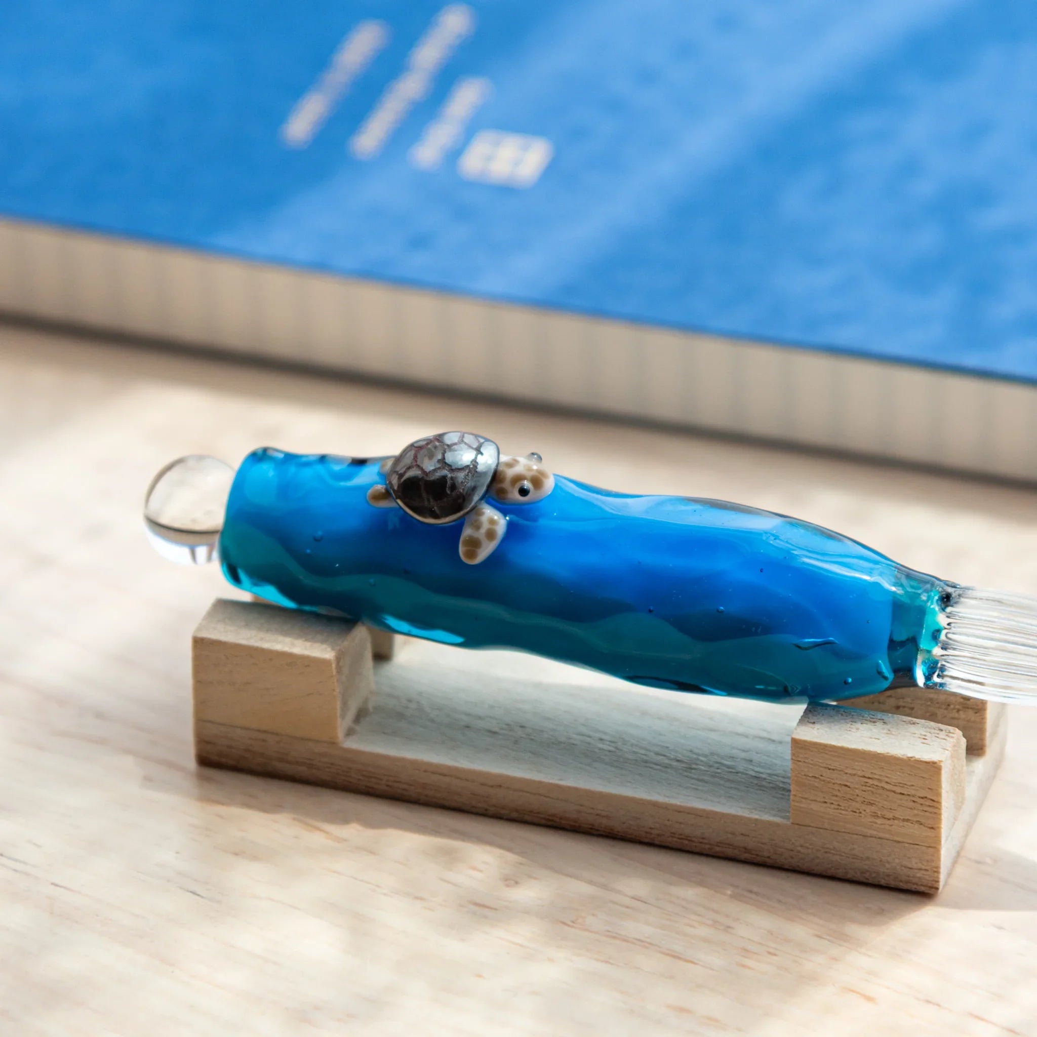 Glass dip pen featuring sea turtle figure floating inside clear barrel, detailed Japanese stationery item