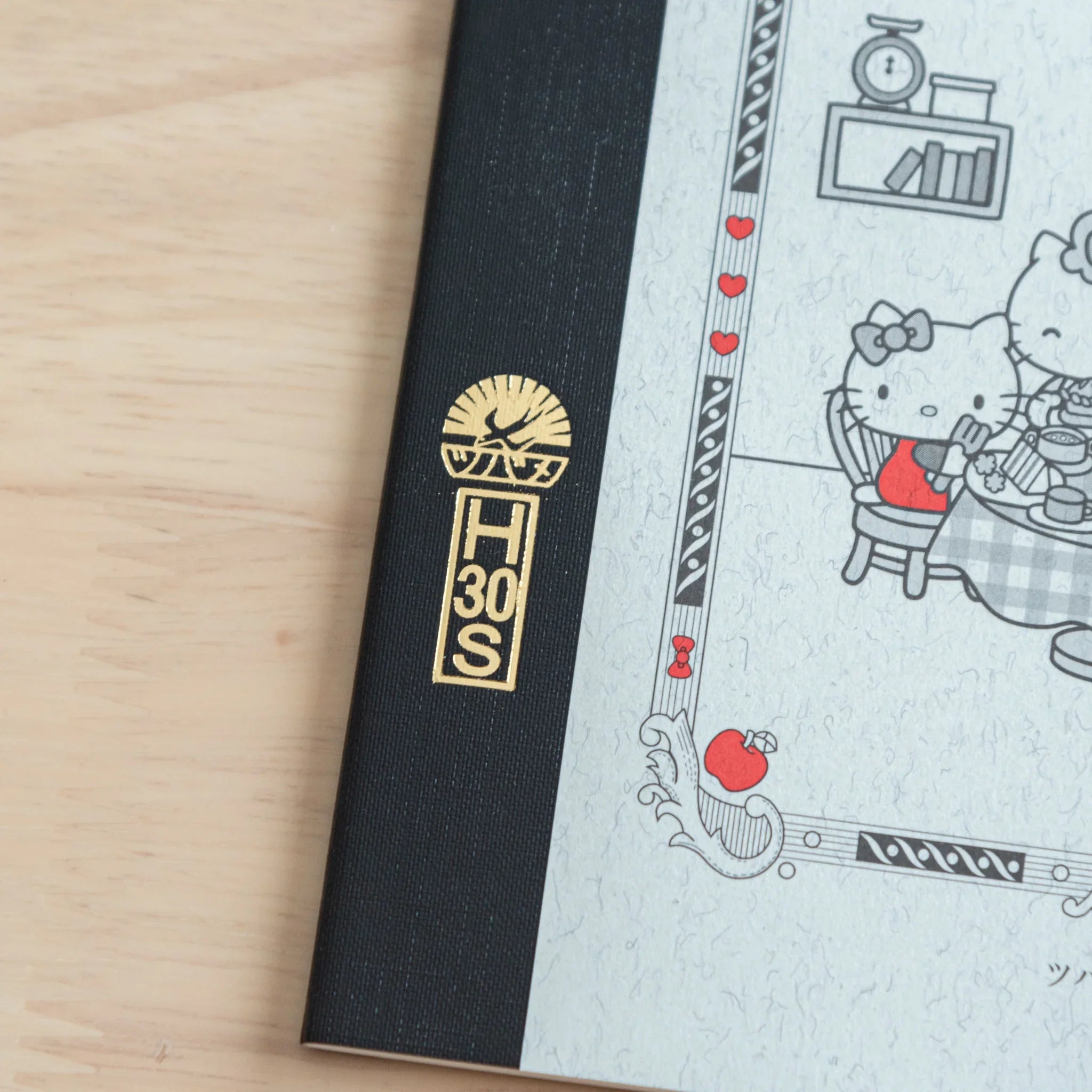Hello Kitty Tsubame Foold Notebook Grid A5 opened flat displaying blue grid paper pages and sewn spine binding
