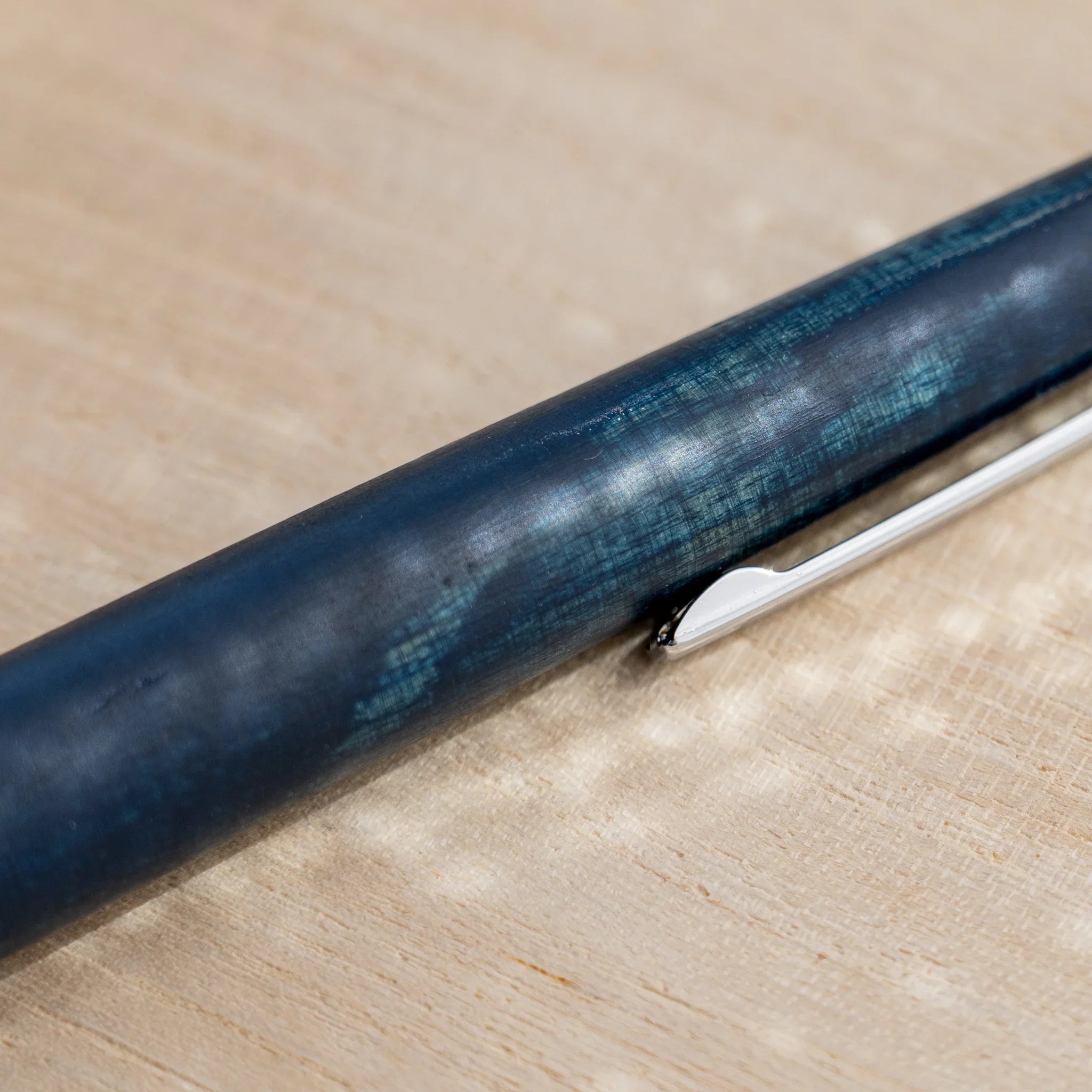 Indigo blue horse chestnut wood urushi ballpoint pen, close-up of barrel wood grain, Japanese wood