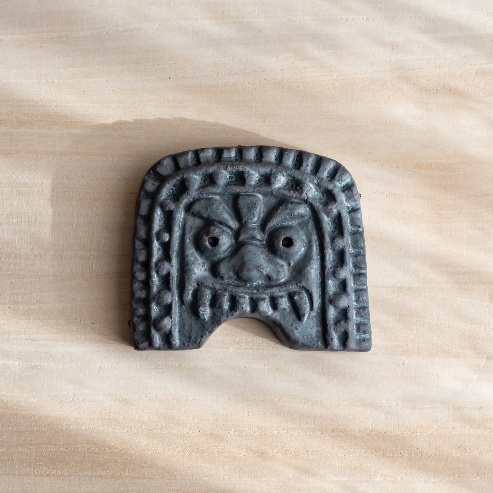 Japanese Kawara Roof Guardian Paperweight Medium square face lifestyle shot showing paperweight in use