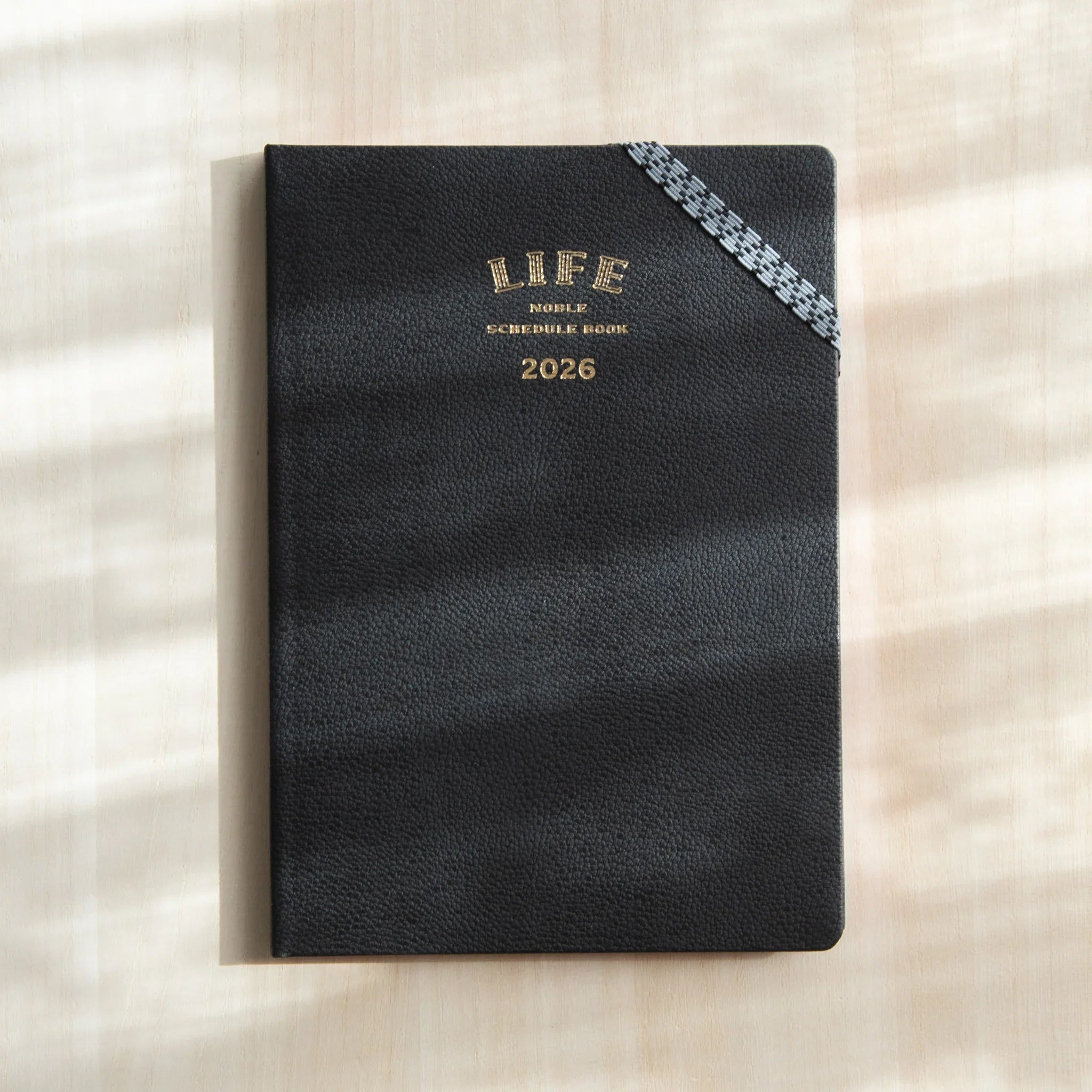 Life Noble 2026 schedule book, navy cover, front cover view highlighting gold foil embossing