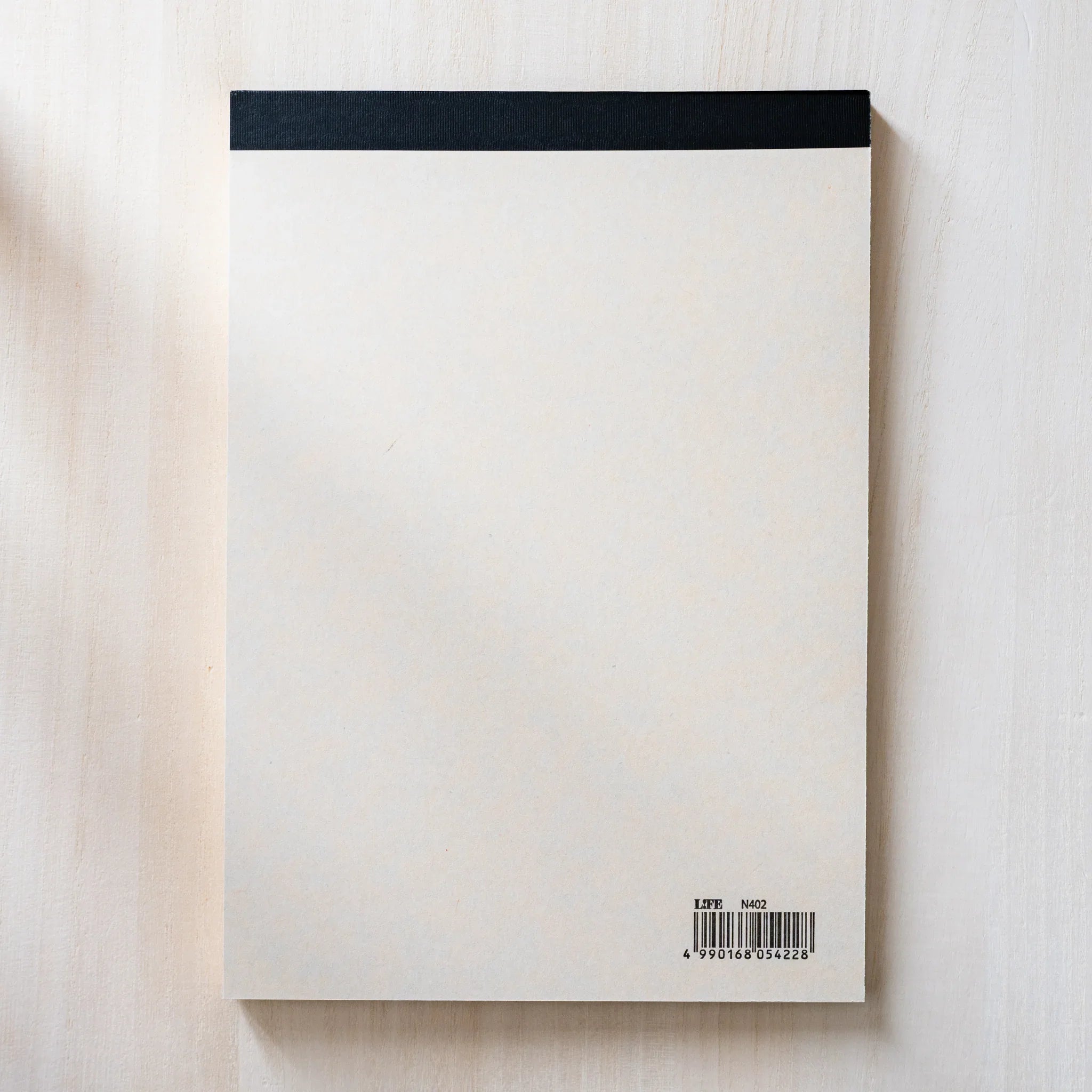 Life Noble A5 writing pad with decorative pattern, flat lay displaying demonstrating binding detail