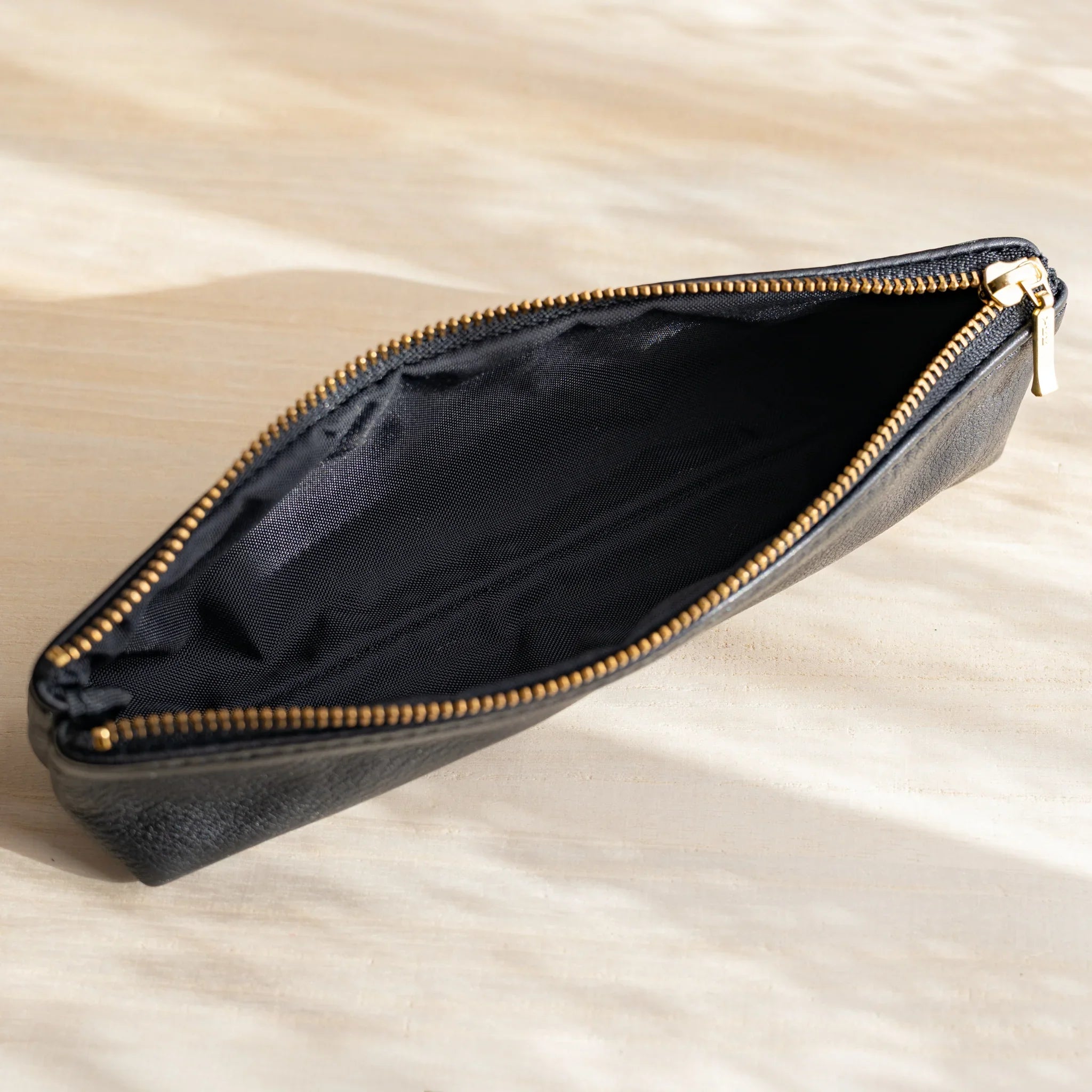 Leather case held in hand showing size and weight distribution and features and features and features