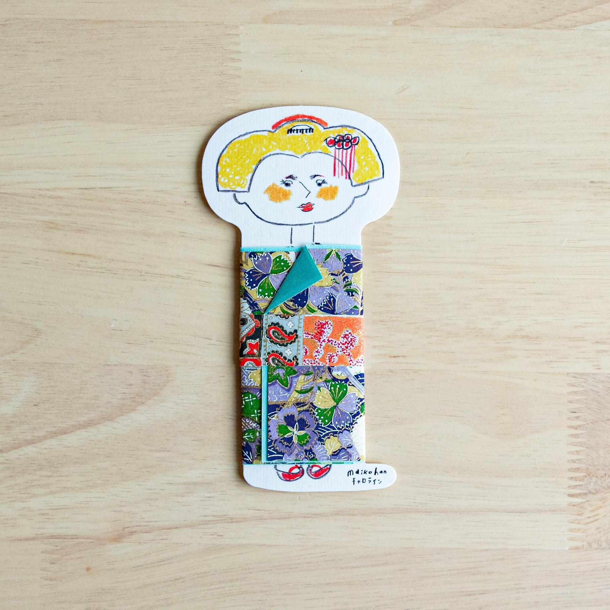 Maikohan Message Card on wood, yellow-haired maiko in purple floral yuzen washi kimono with orange and teal obi accents