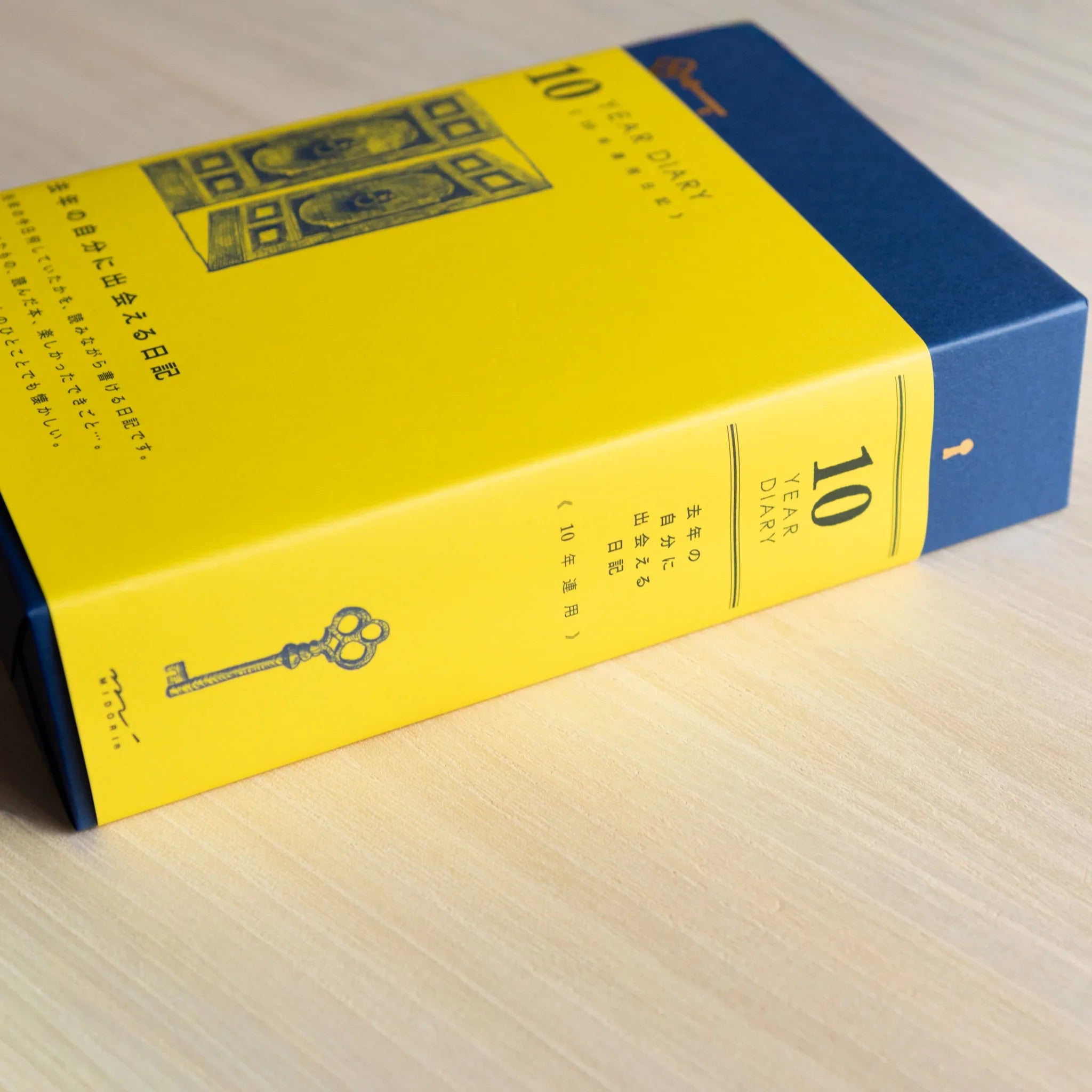 Midori 10-year journal, opened pages displaying yearly date sections with ruled lines, Japanese stationery with quality