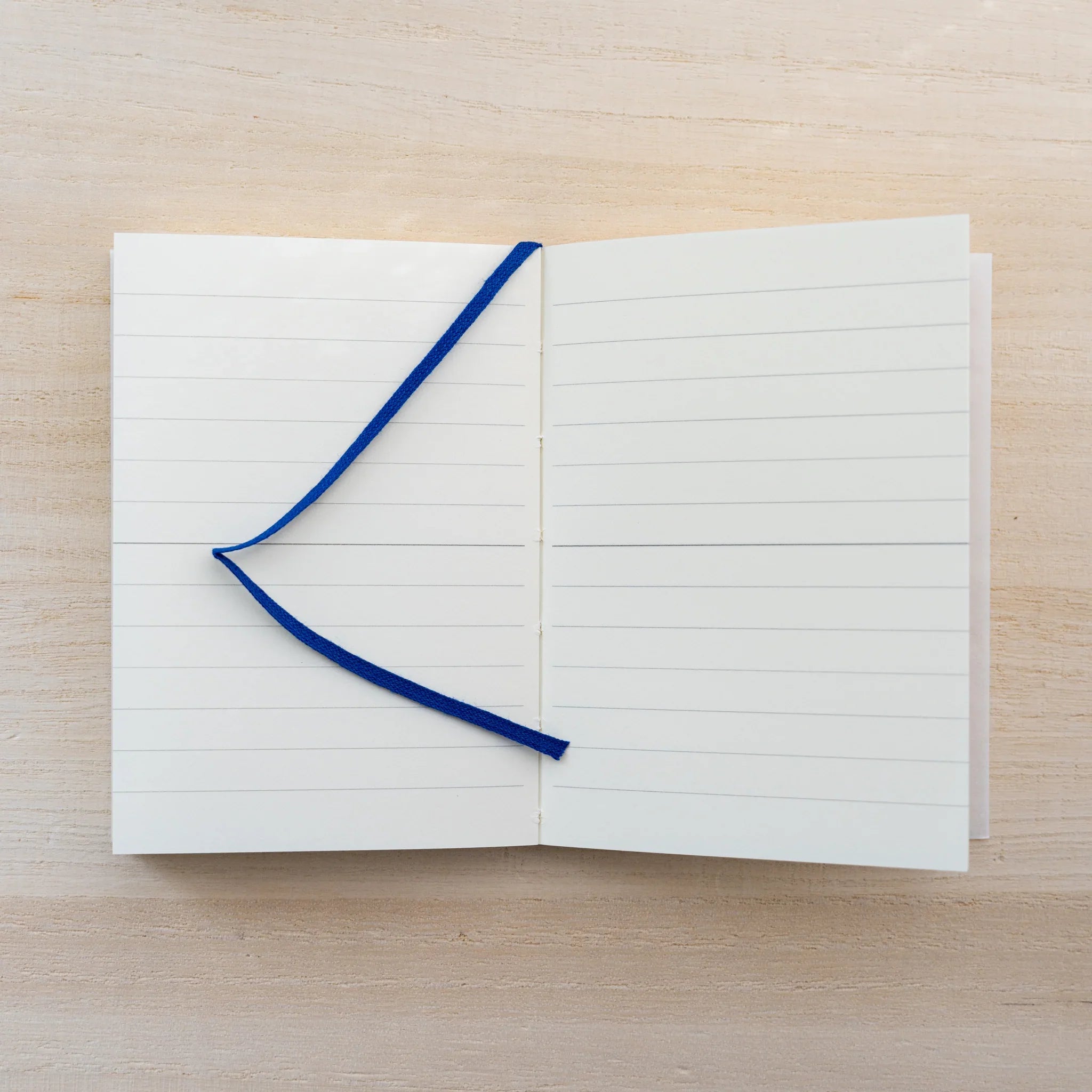 MD Notebook A7 opened to a dot grid spread with blue ink lines