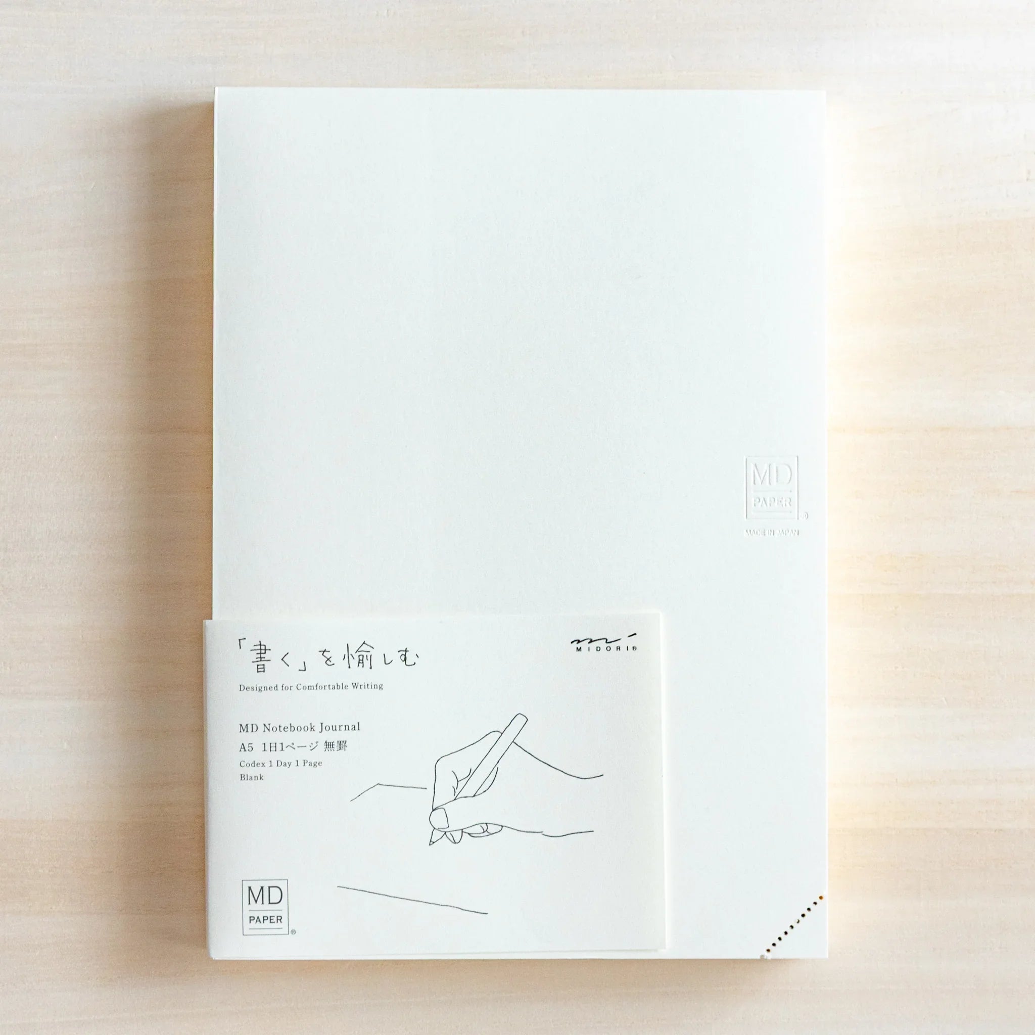 Midori MD A5 journal, cover flat lay displaying front cover composition, Japanese Midori MD notebook with cotton-smooth paper