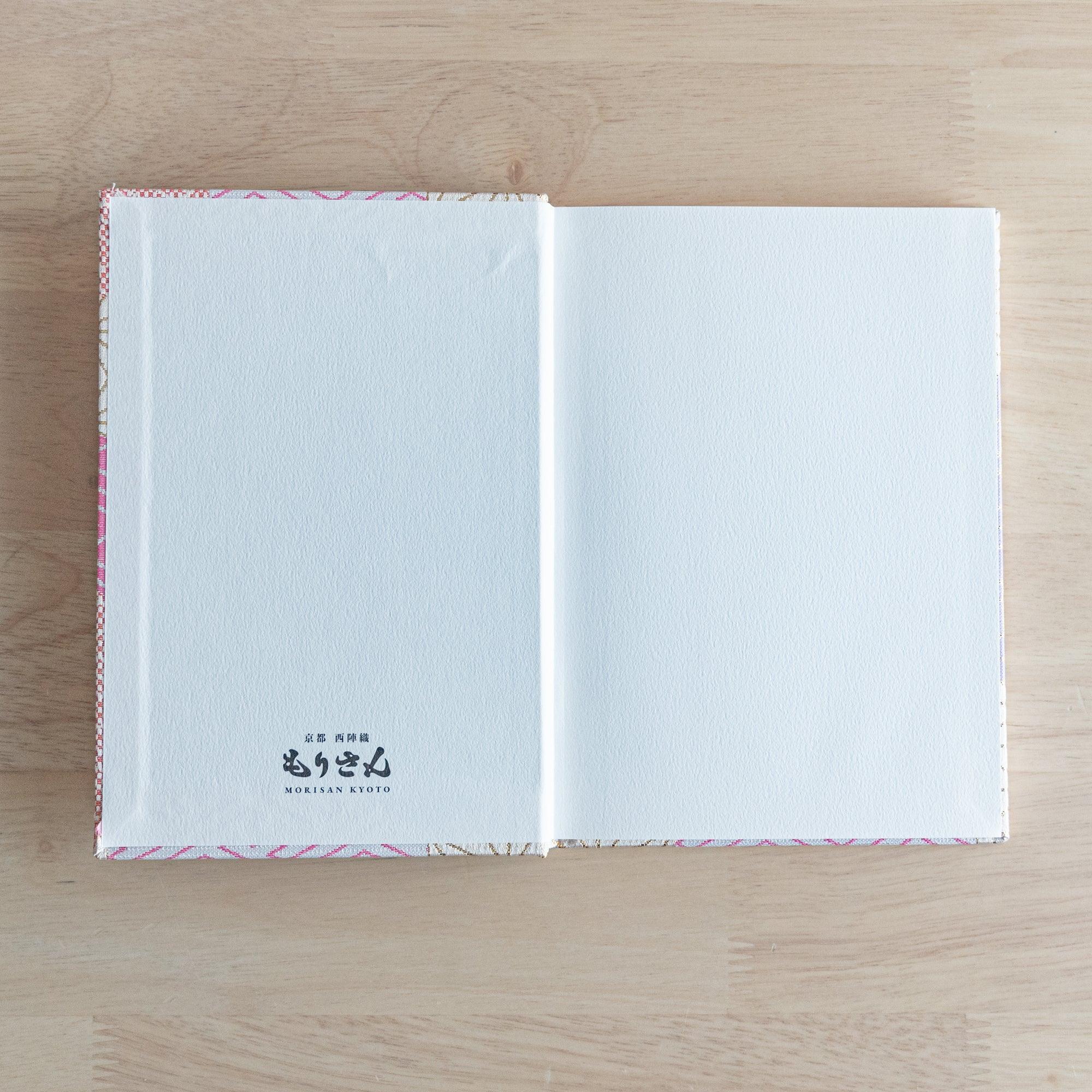 Nishijin textile B6 journal, fully opened showing quality paper and traditional brocade cover with binding