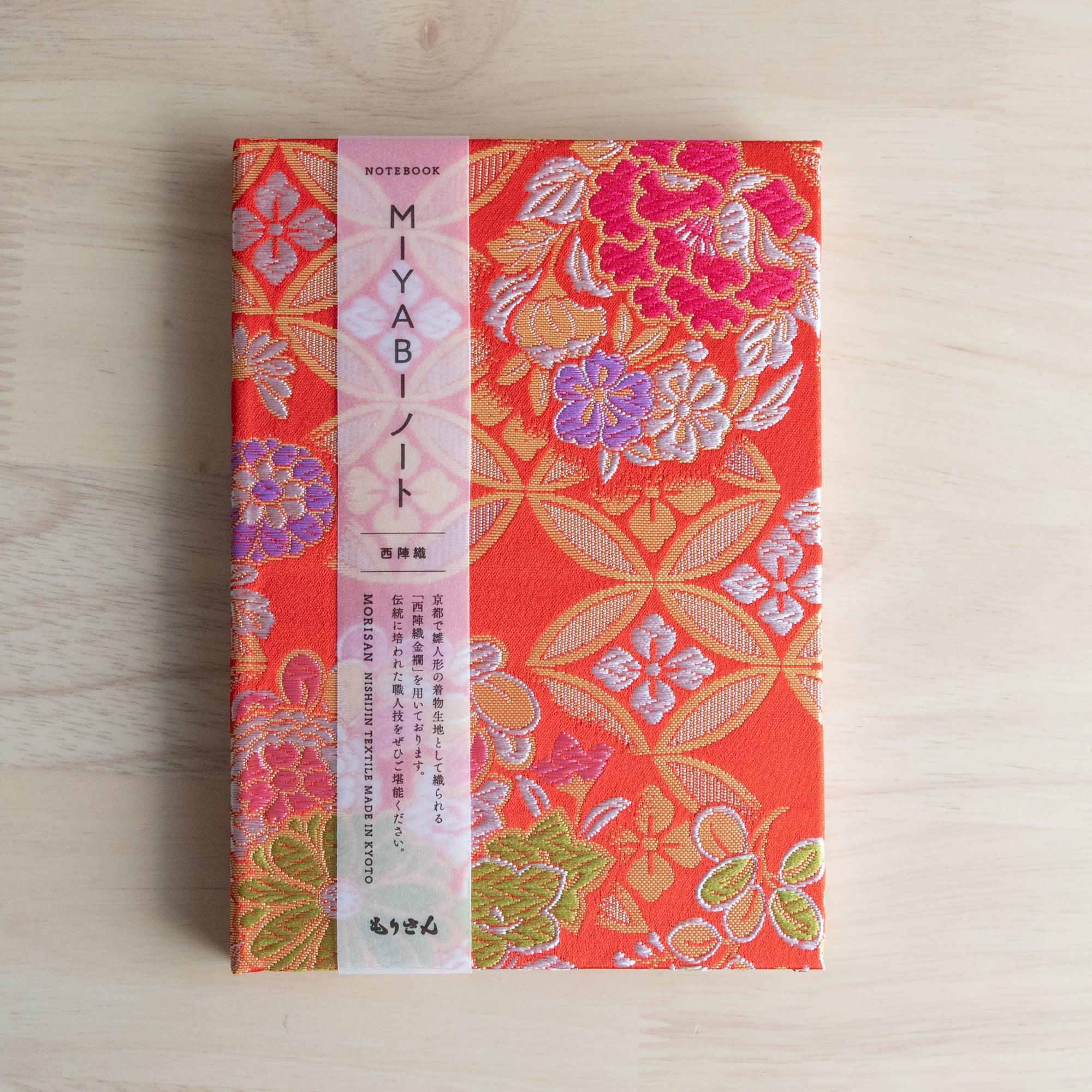 Nishijin textile Japanese notebook with orange-red shippo floral cover and pink belly band reading MIYABI Notebook MORISAN