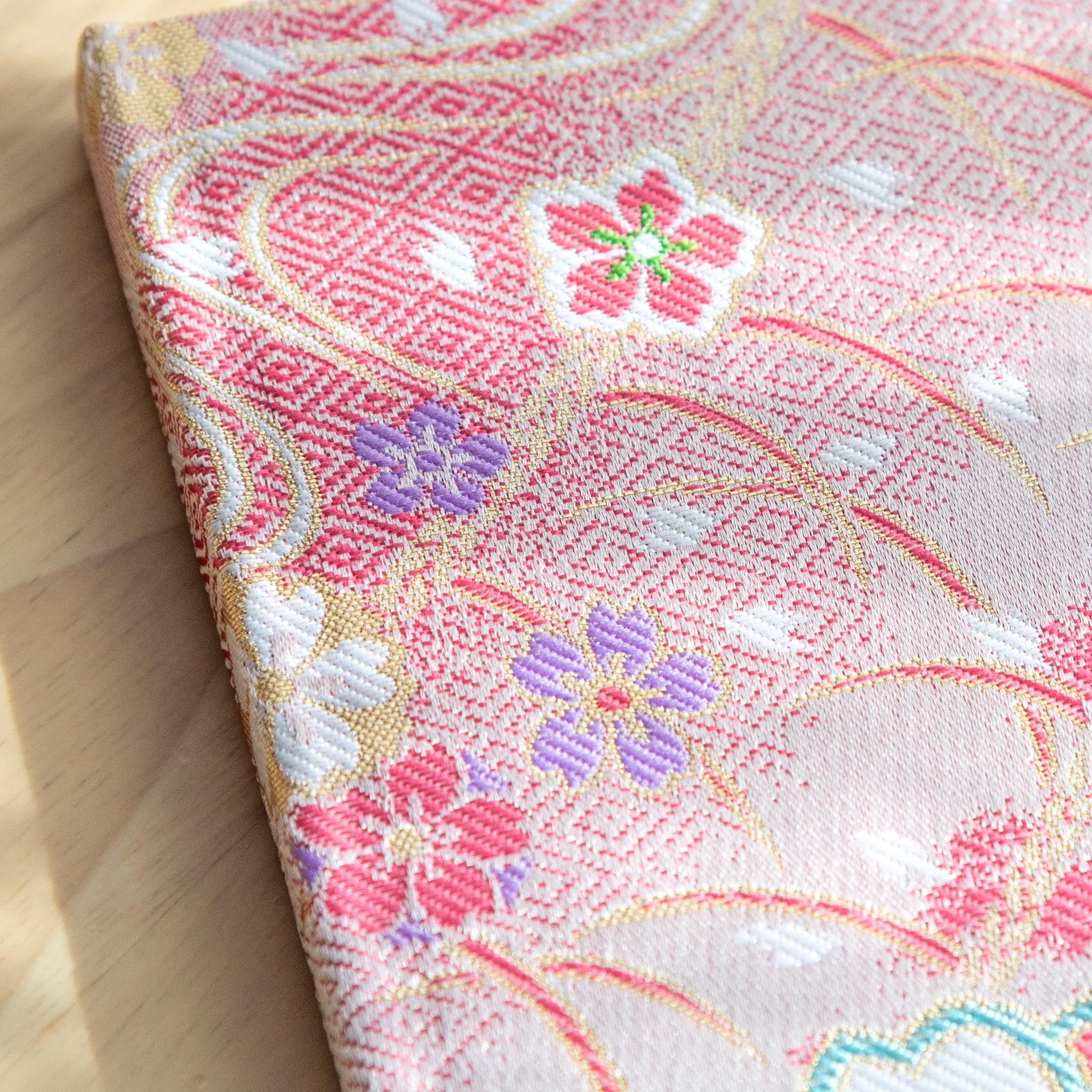 Japanese Nishijin textile B6, angled shot of traditional brocade Sakura cherry blossom pattern with binding