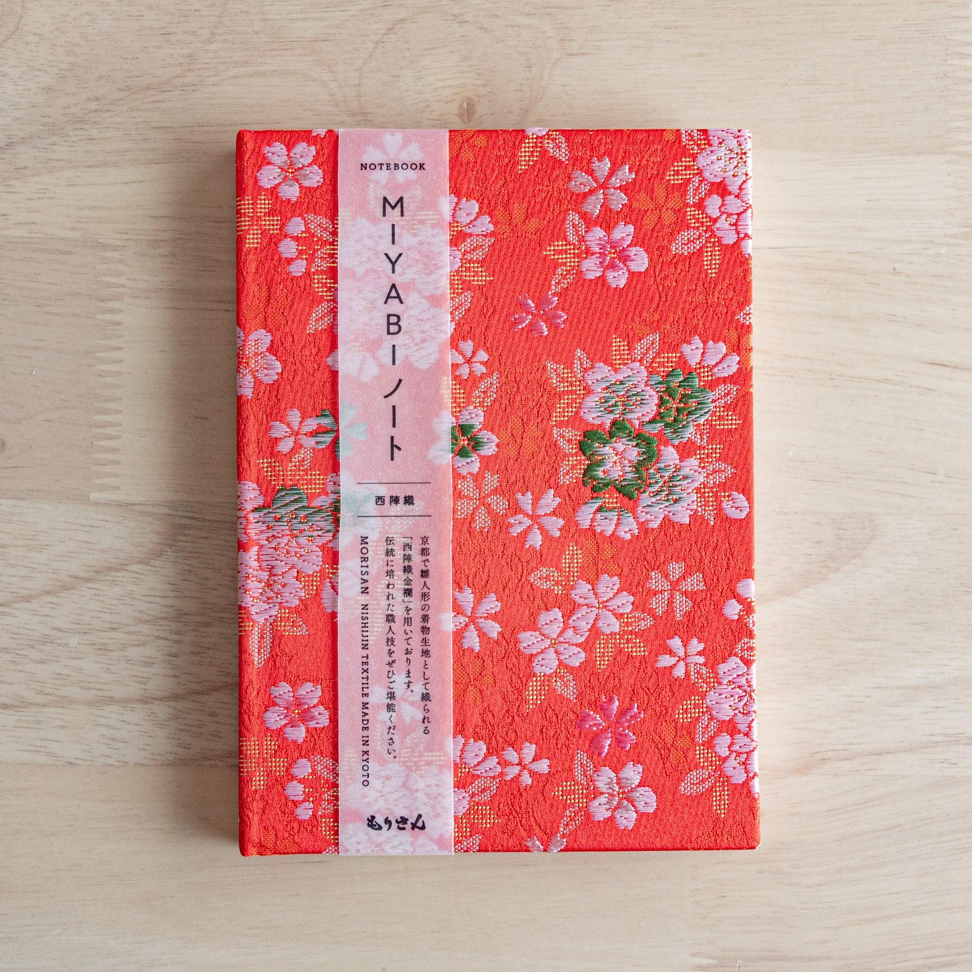 Japanese Nishijin textile B6, angled shot of traditional brocade Sakura Ensemble pattern with binding