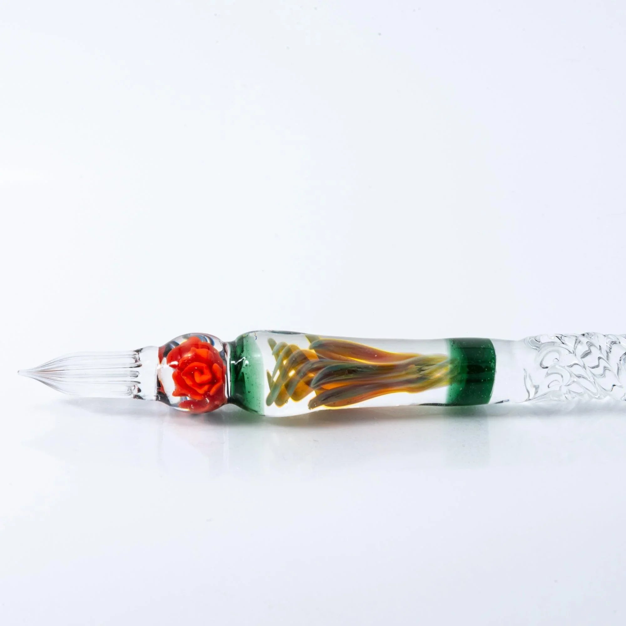 Orange Rose glass dip pen being used for writing on paper demonstrating metal nib flexibility in action with holder