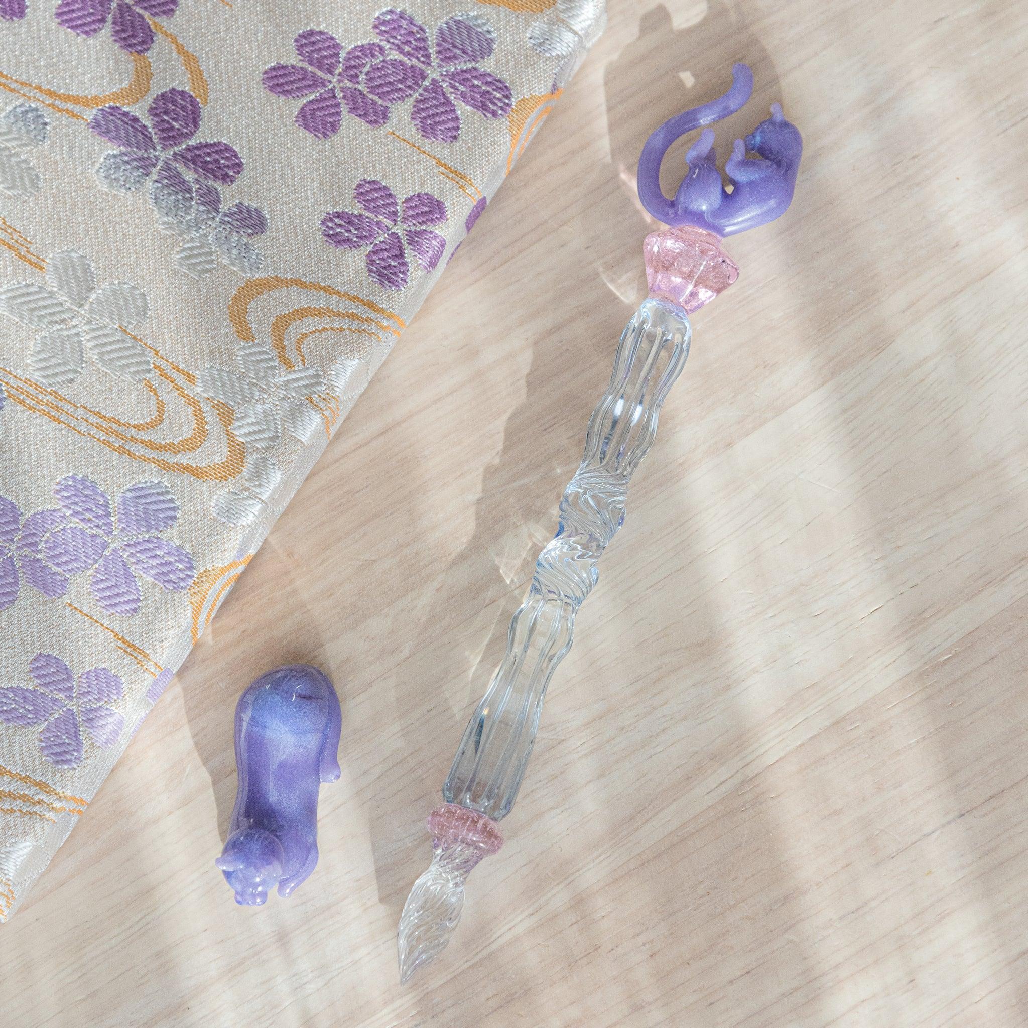 Pastel Purple Cat Glass Dip Pen with matching ceramic pen rest set, both displaying feline features in complementary hues