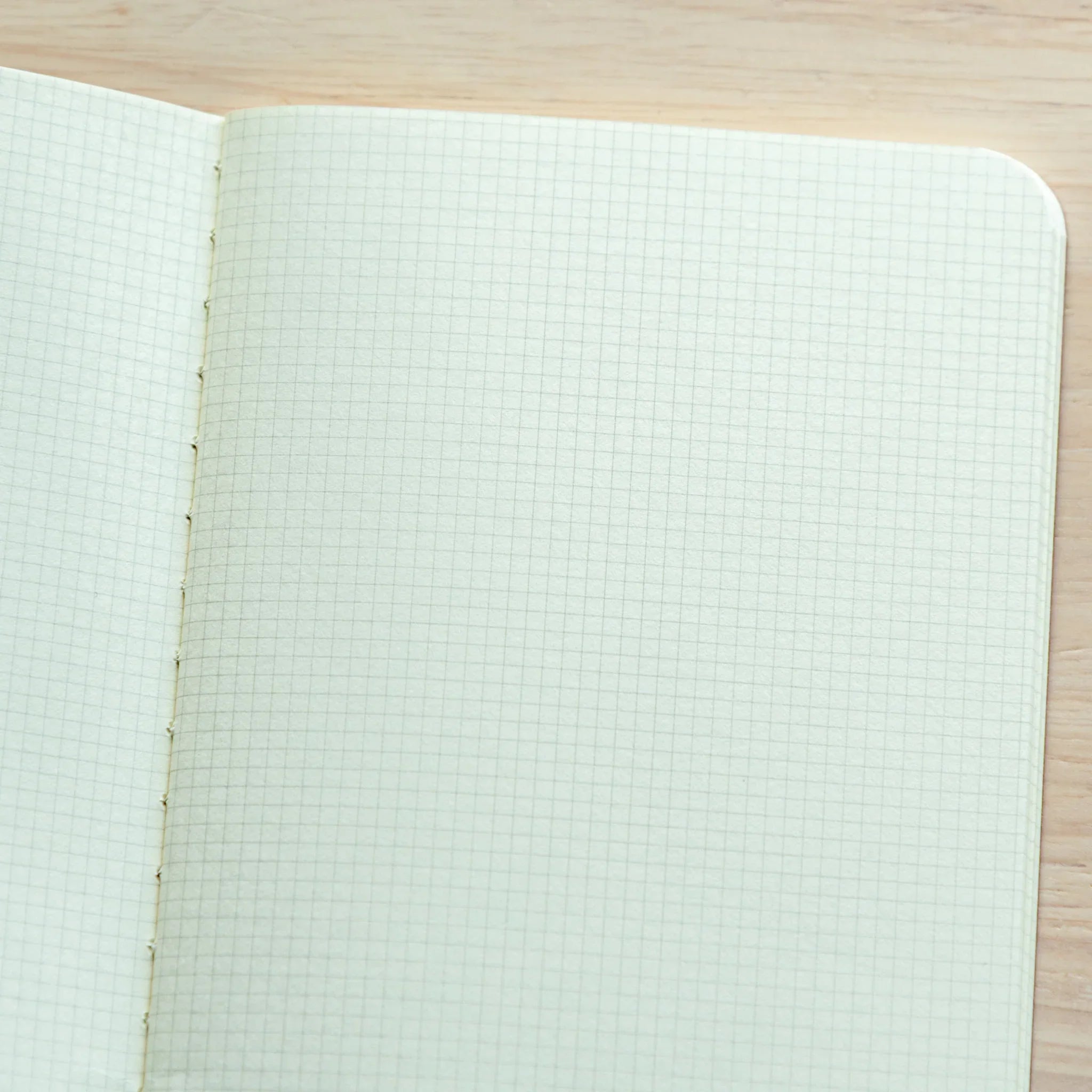 RO-BIKI Basic notebook with 2mm grid ruling shown flat on surface, displaying slate cover and organized writing space