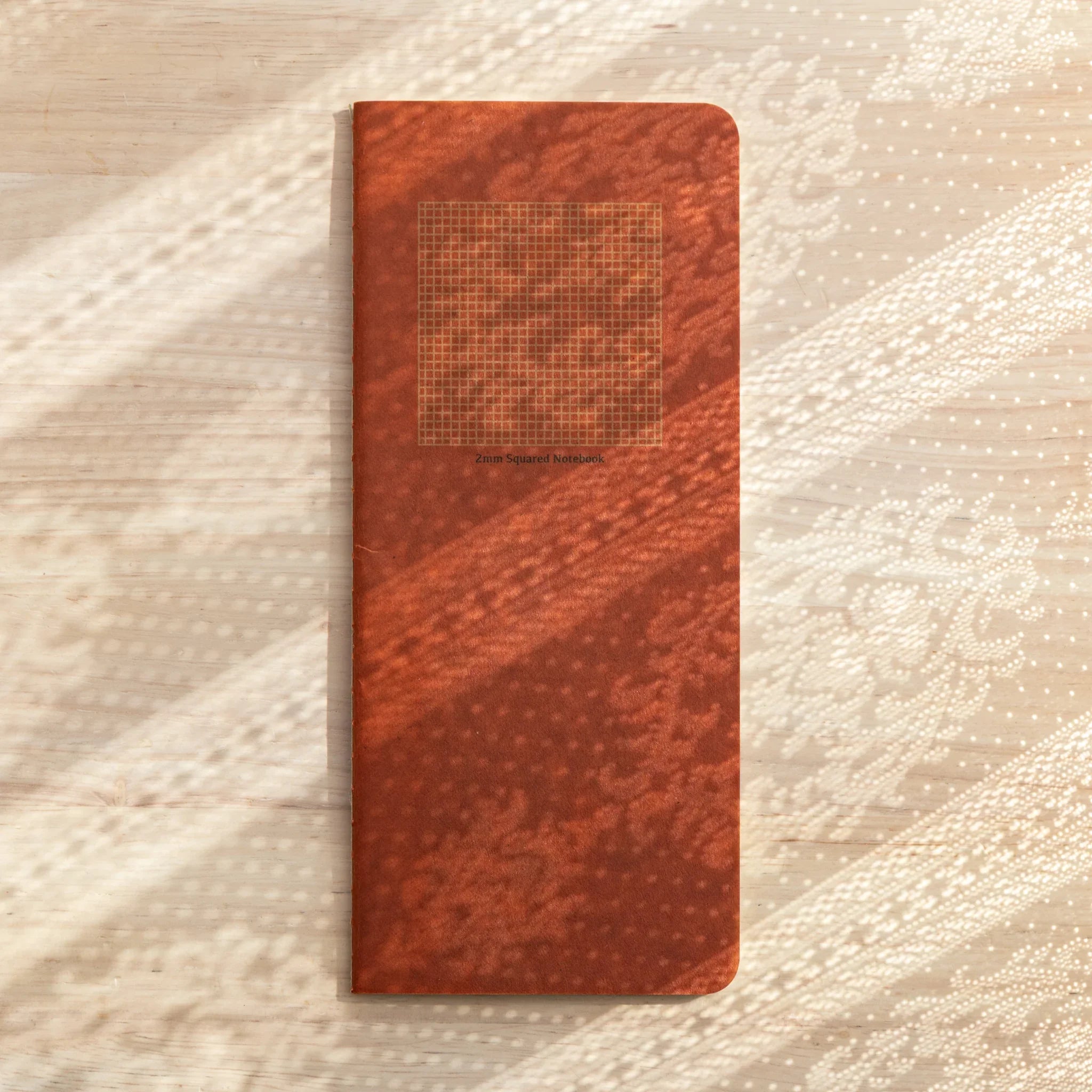 RO-BIKI Basic Series 2mm grid notebook displayed flat showing interior ruling pattern and cover, Japanese quality stationery