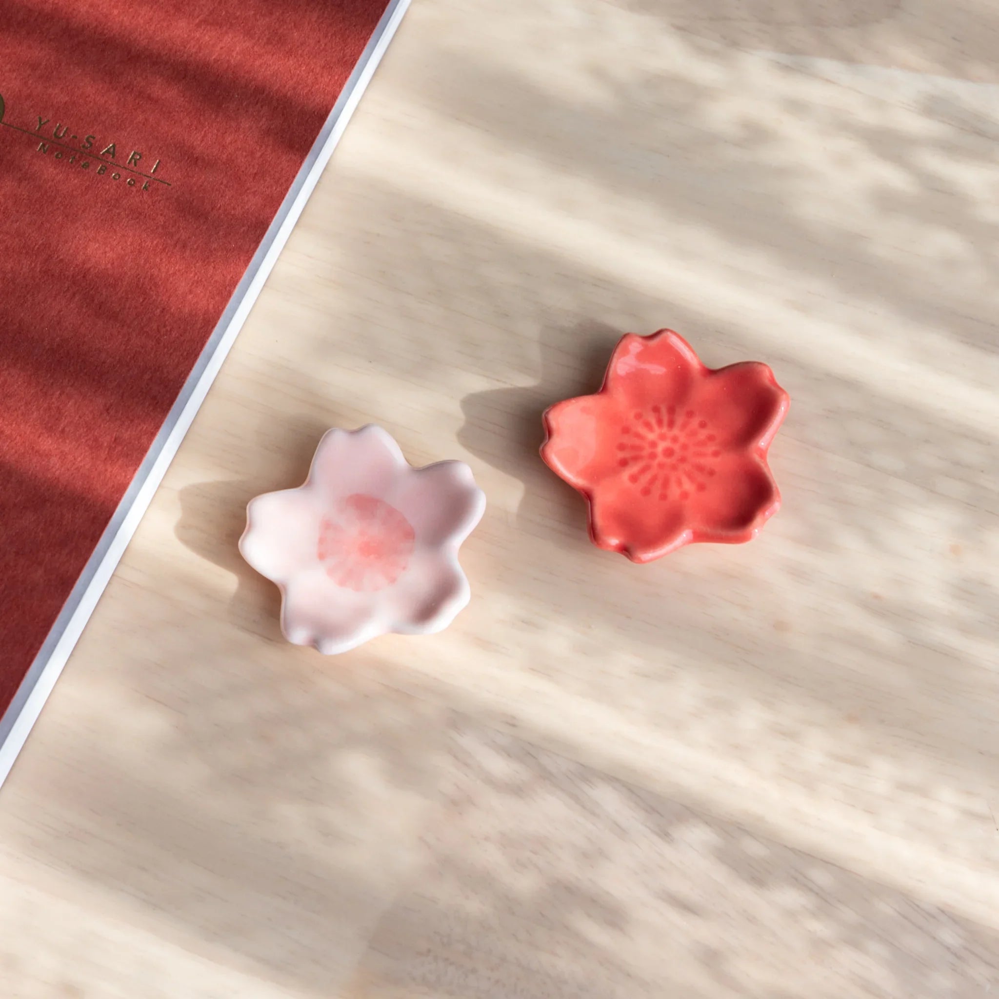 Pink cherry blossom sakura shaped handcrafted pen rest with six delicate flower petals showing Japanese spring season theme