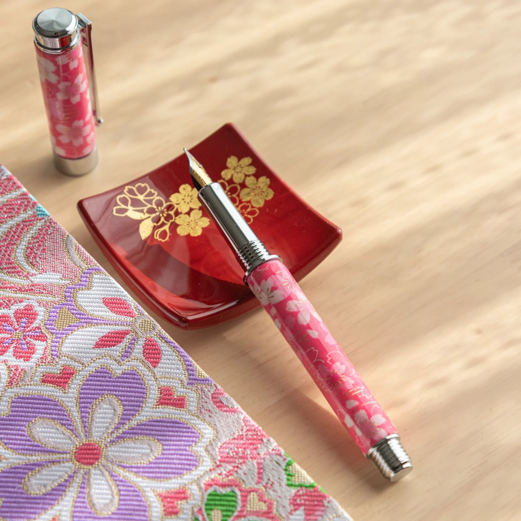 Sakura Over the River Mino washi fountain pen showing pink sakura pattern with traditional river landscape angle