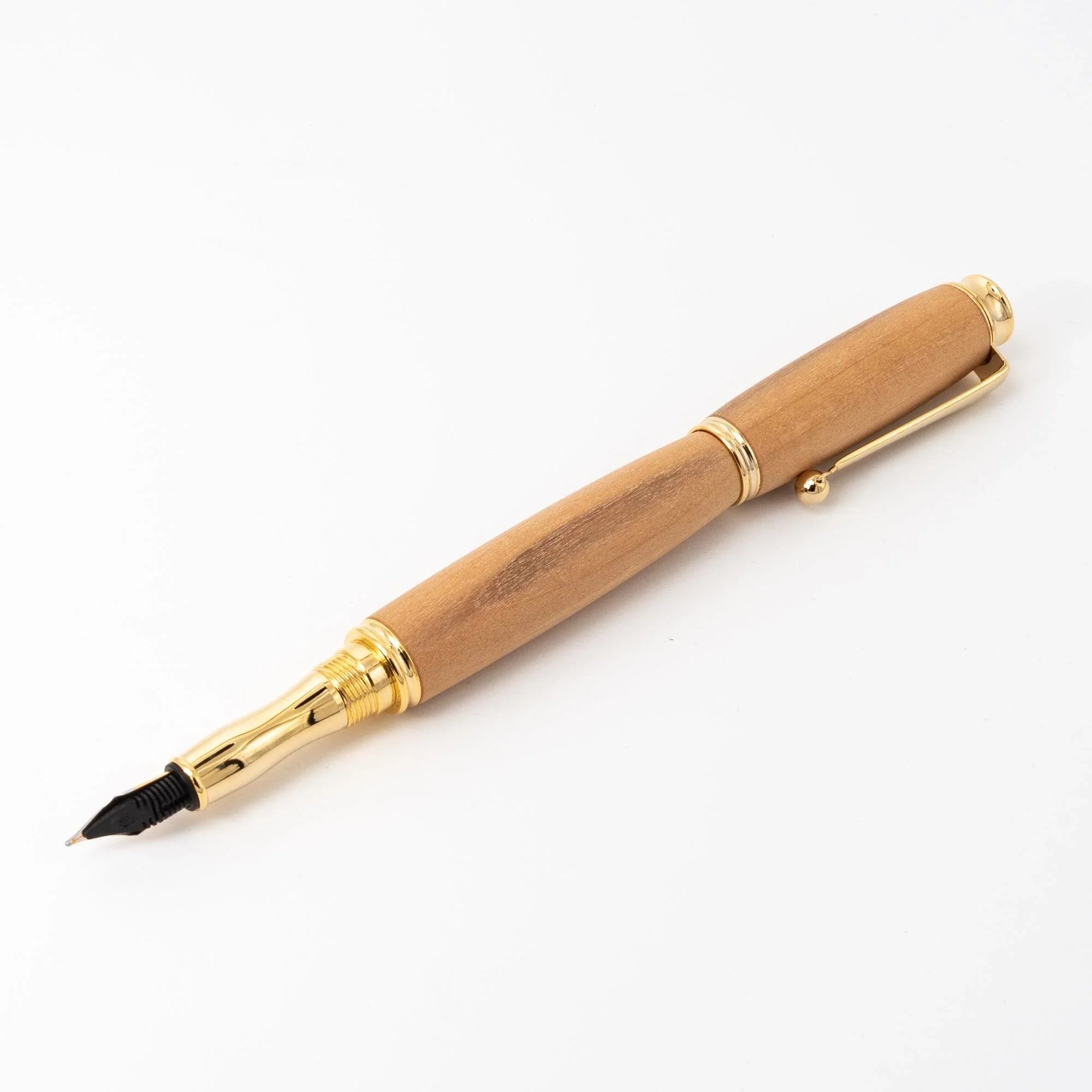 Natural wood Japanese fountain pen cap posted on barrel, showing full length from gold nib to dome cap, trim ring visible