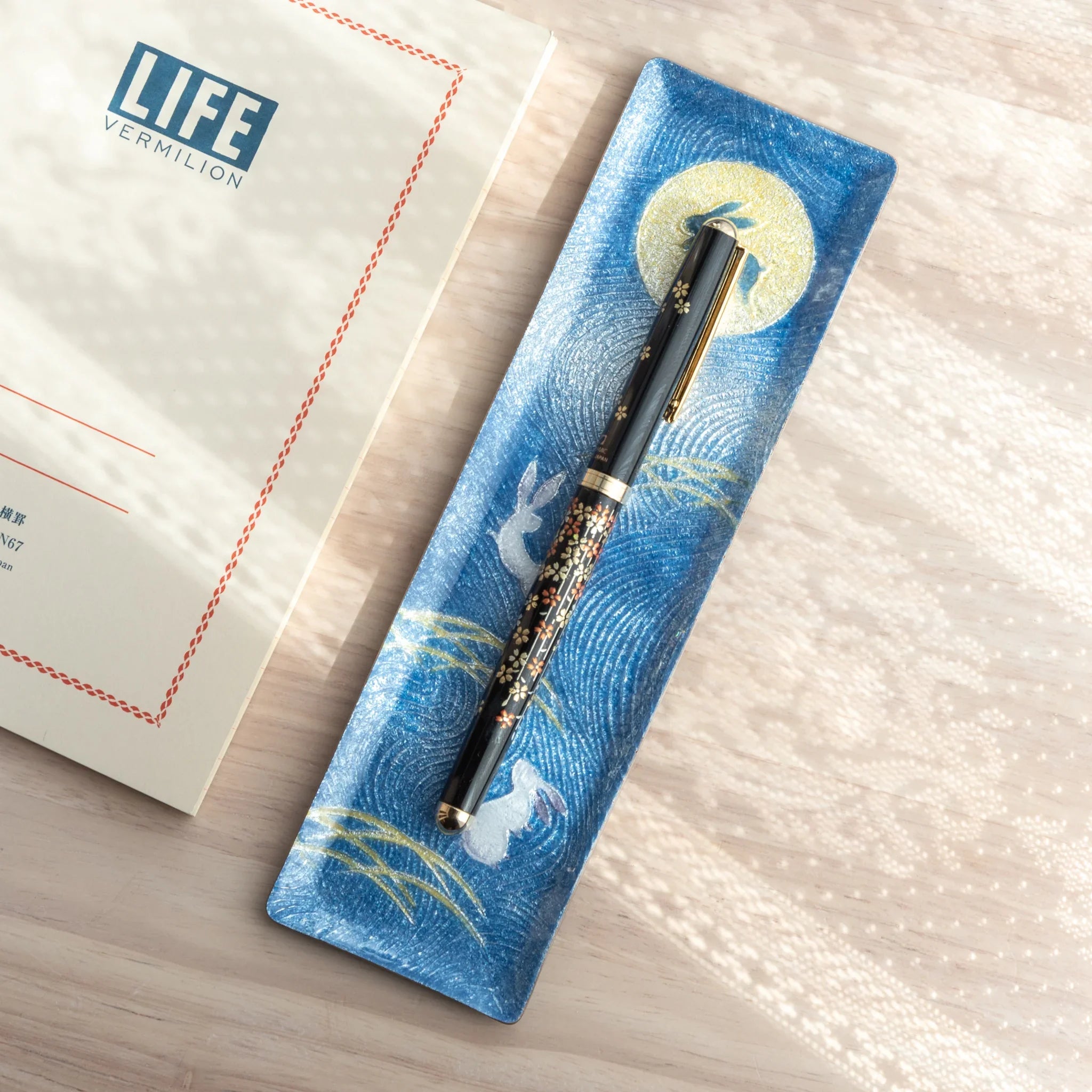 Traditional Japanese Yamanaka ballpoint pen features sakura flower and botanical branch artwork for writing