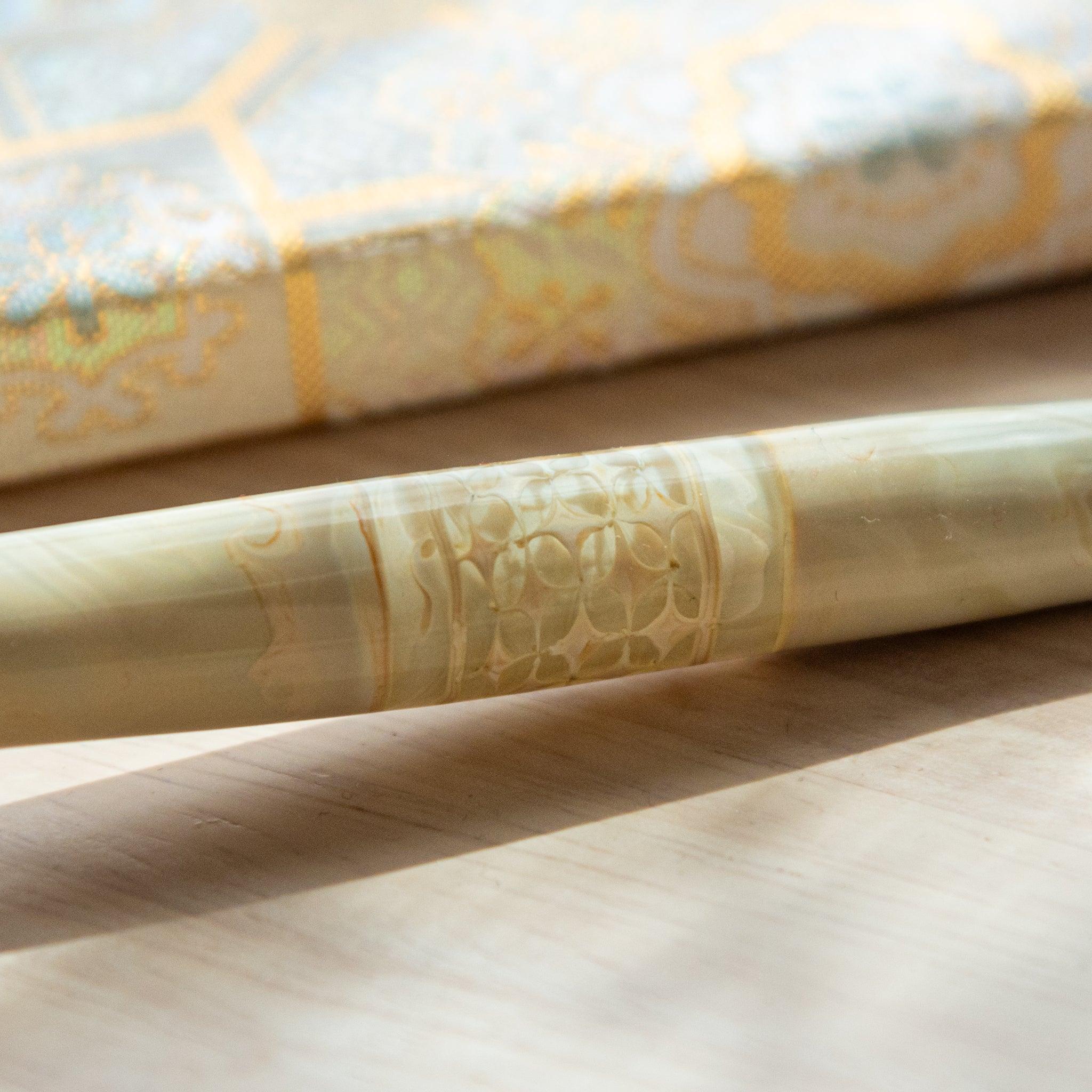 Product shot of shippo wooden dip pen with engraved geometric cloisonne-style motif and Japanese design in frame